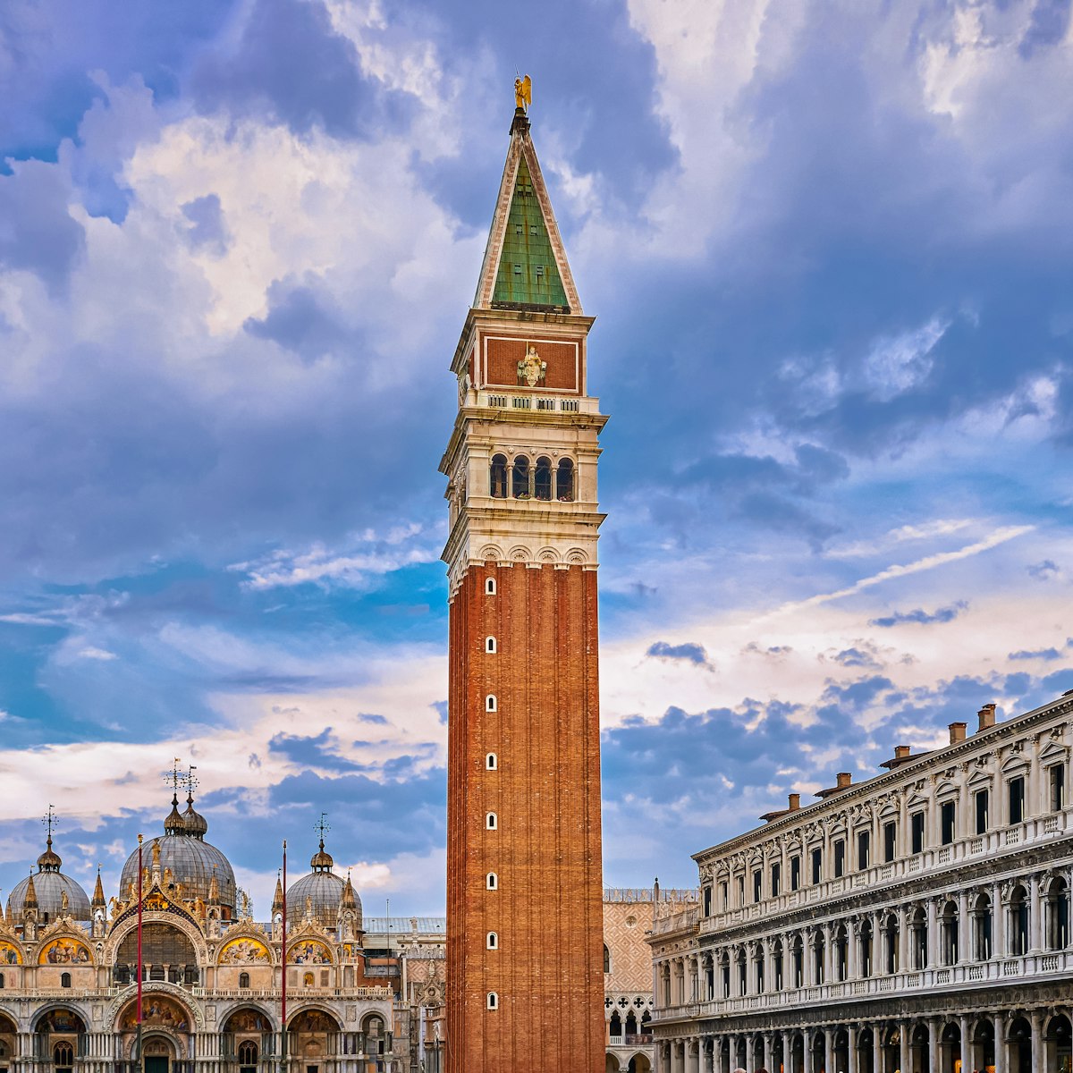 View of St Mark's square or piazza di San Marco, Venice, Italy, sundown on cloudy day. Bell tower or Campanile, St Mark's Basilica main facade and entrance and Procurate Vecchie building, beautiful sky and clouds, UNESCO World heritage city.
1584875726
View of St Mark's square or piazza di San Marco, Venice, Italy in sundown on cloudy day. Campanile, St Mark's Basilica, Procurate Vecchie building