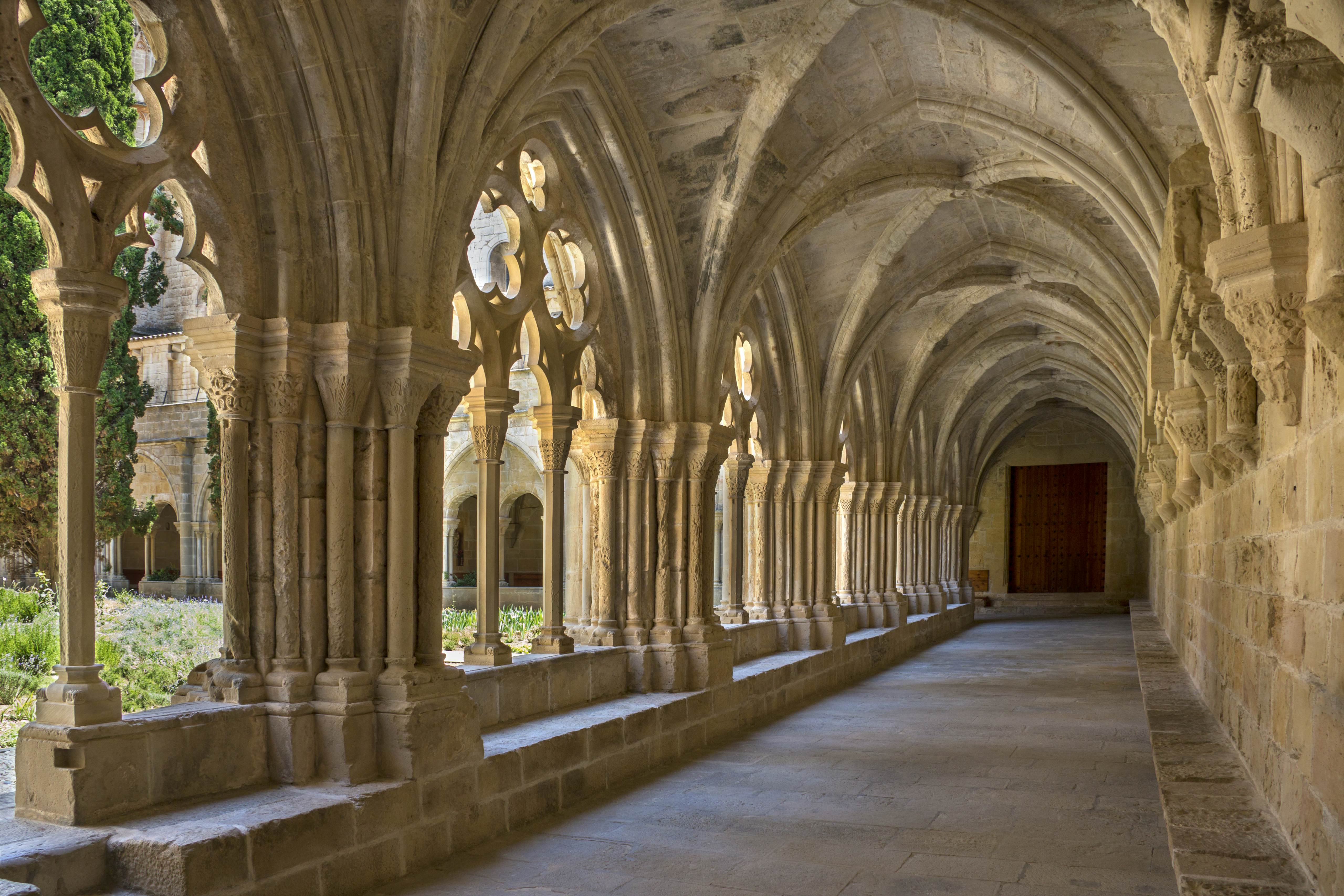 The cloisters at the Cistercian Monastery of Santa Maria de Poblet (Monestir de Poblet) in the Catalonia region of Spain. Parts of the monastery date from the 1150. The monks make their own wine and the monastery is surrounded by vineyards.