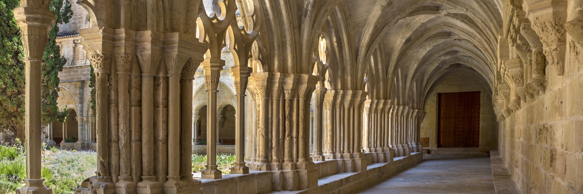 The cloisters at the Cistercian Monastery of Santa Maria de Poblet (Monestir de Poblet) in the Catalonia region of Spain. Parts of the monastery date from the 1150. The monks make their own wine and the monastery is surrounded by vineyards.