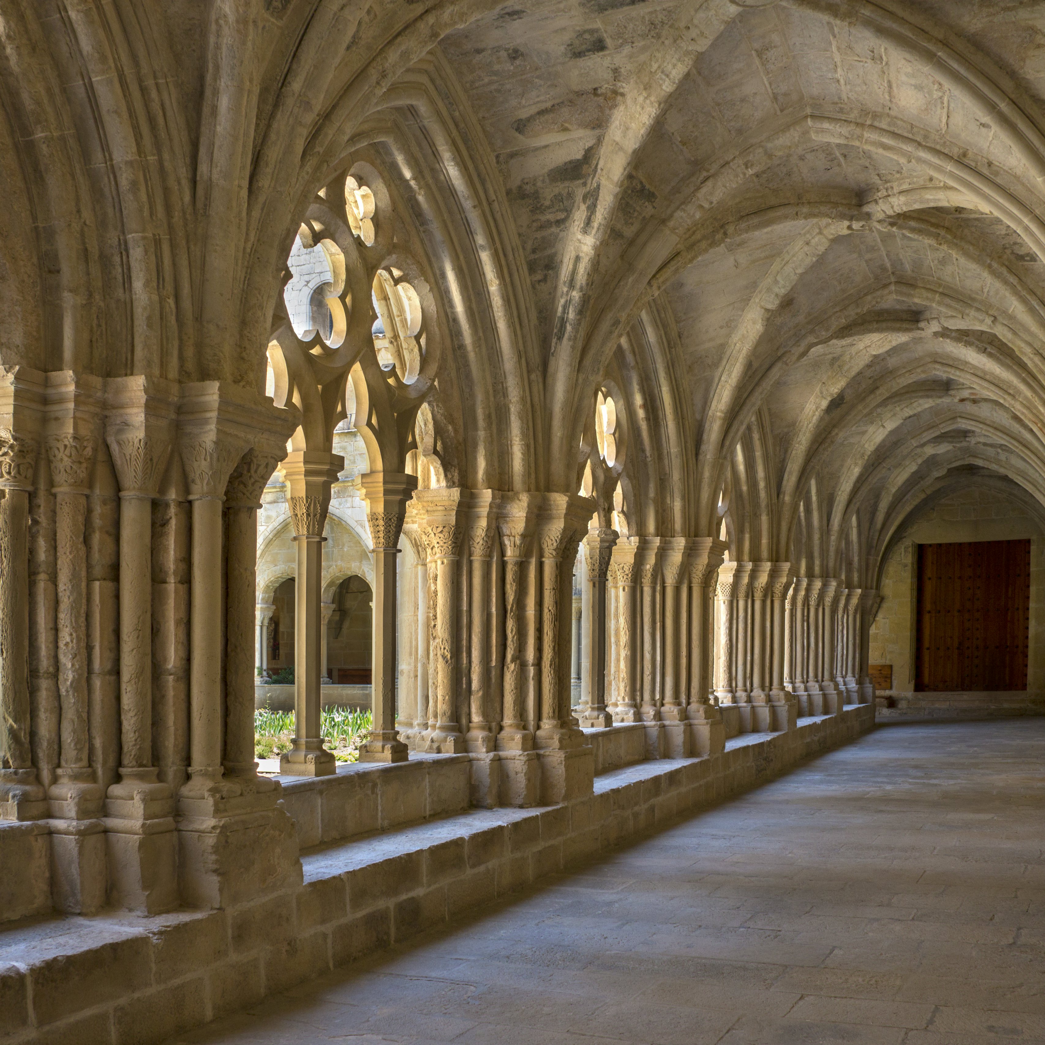 The cloisters at the Cistercian Monastery of Santa Maria de Poblet (Monestir de Poblet) in the Catalonia region of Spain. Parts of the monastery date from the 1150. The monks make their own wine and the monastery is surrounded by vineyards.