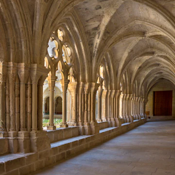 The cloisters at the Cistercian Monastery of Santa Maria de Poblet (Monestir de Poblet) in the Catalonia region of Spain. Parts of the monastery date from the 1150. The monks make their own wine and the monastery is surrounded by vineyards.