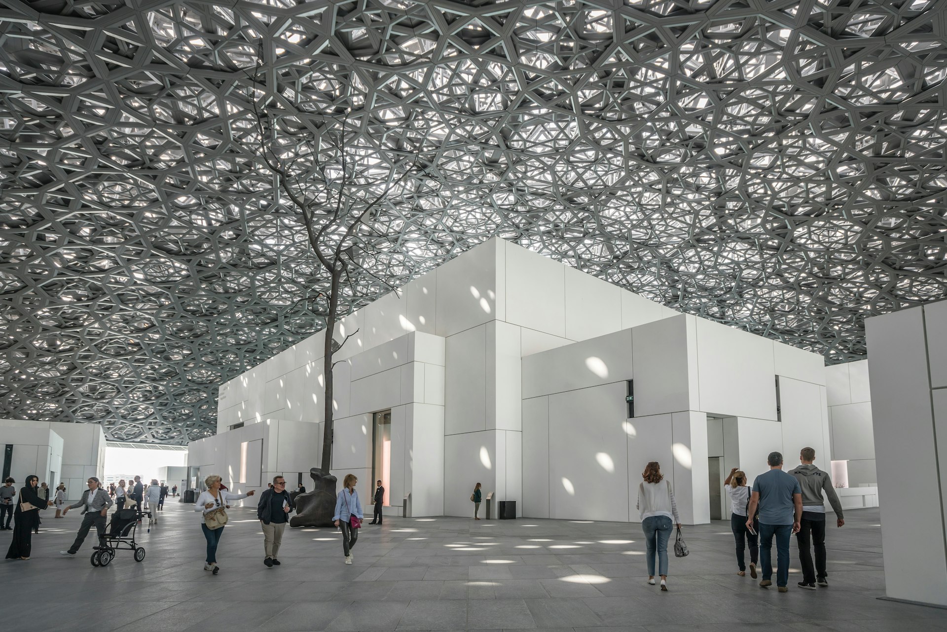 Light pours in through the steel dome of the Louvre Abu Dhabi, Abu Dhabi, United Arab Emirates