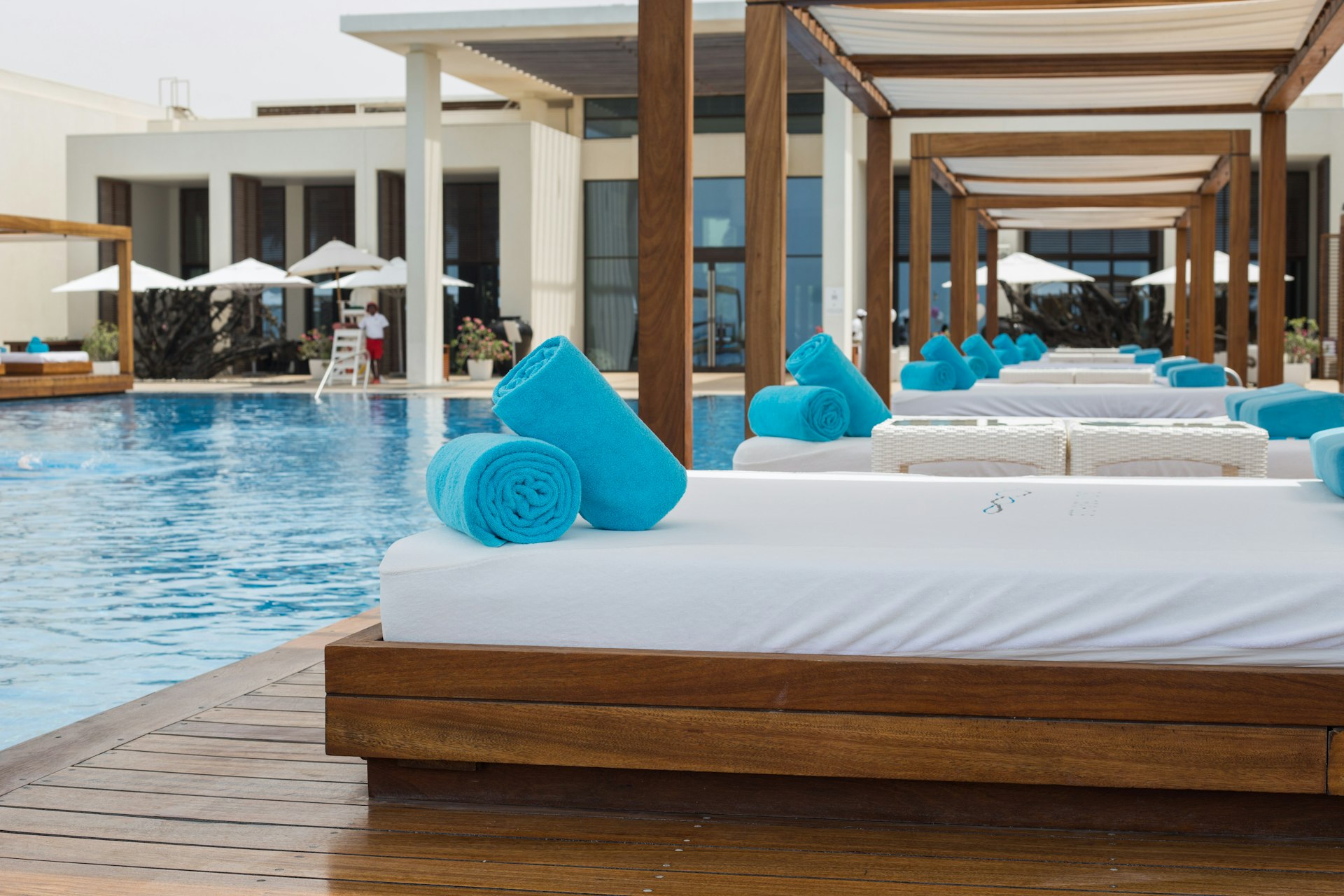 Sun beds by the pool at Saadiyat Beach Club, Abu Dhabi, United Arab Emirates