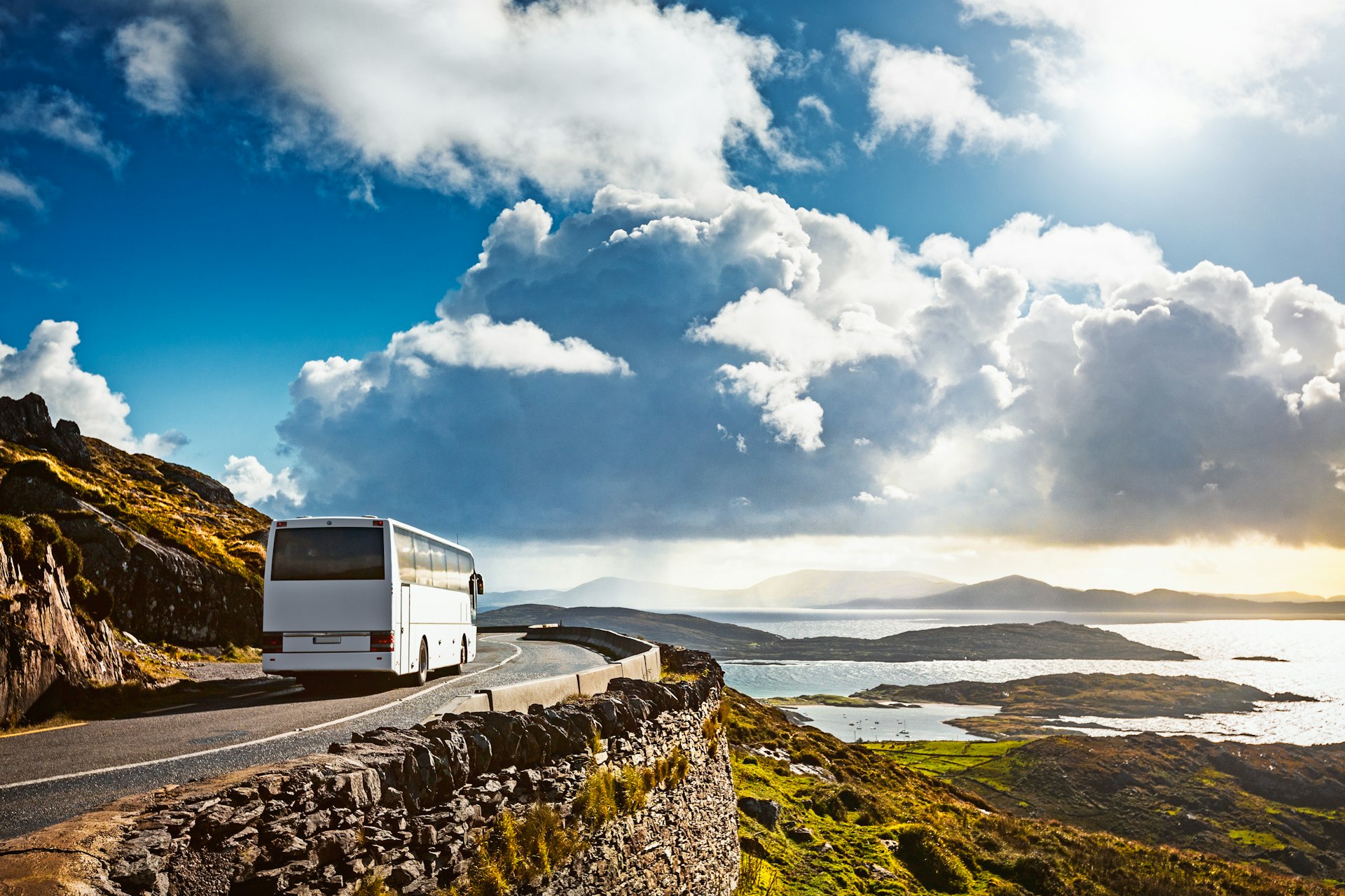 Tourist bus traveling on mountain road. Ring of Kerry, Ireland.