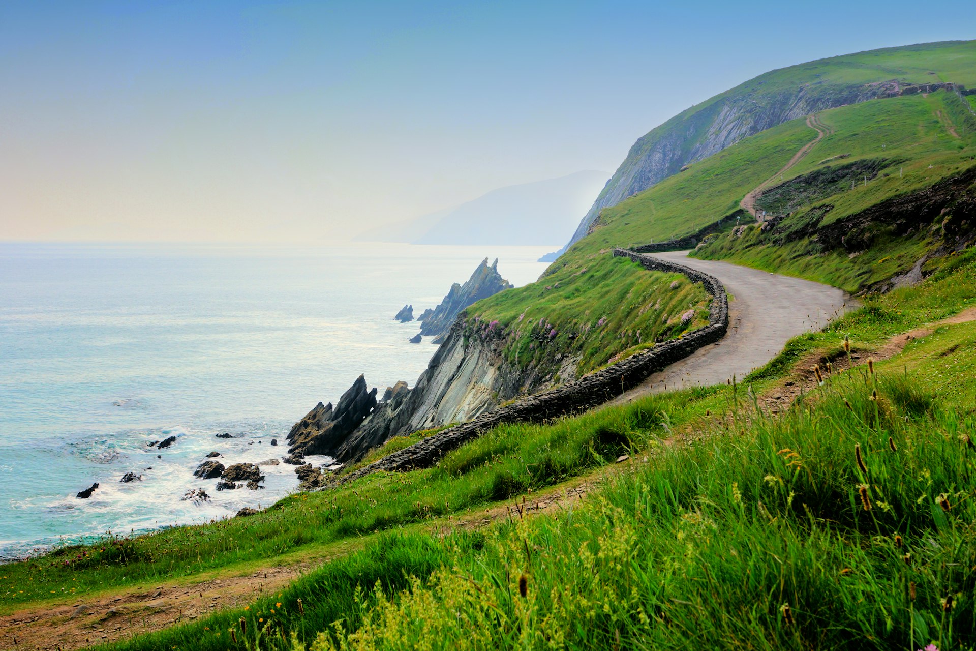 A narrow road along the scenic coast of Slea Head, Dingle Peninsula, County Kerry, Ireland