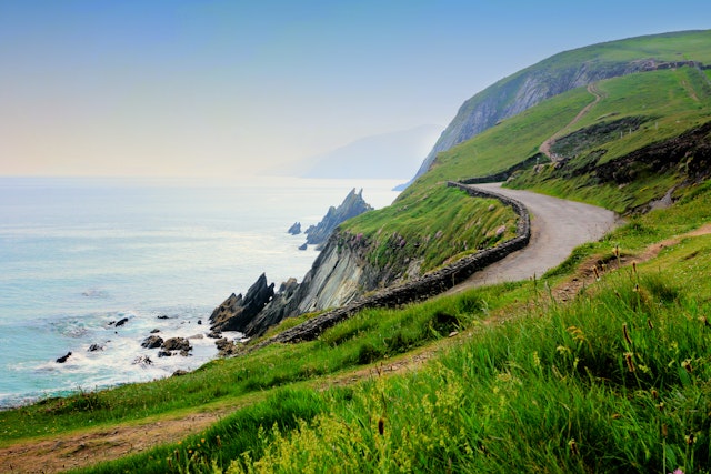 A narrow road along the scenic coast of Slea Head, Dingle Peninsula, County Kerry, Ireland