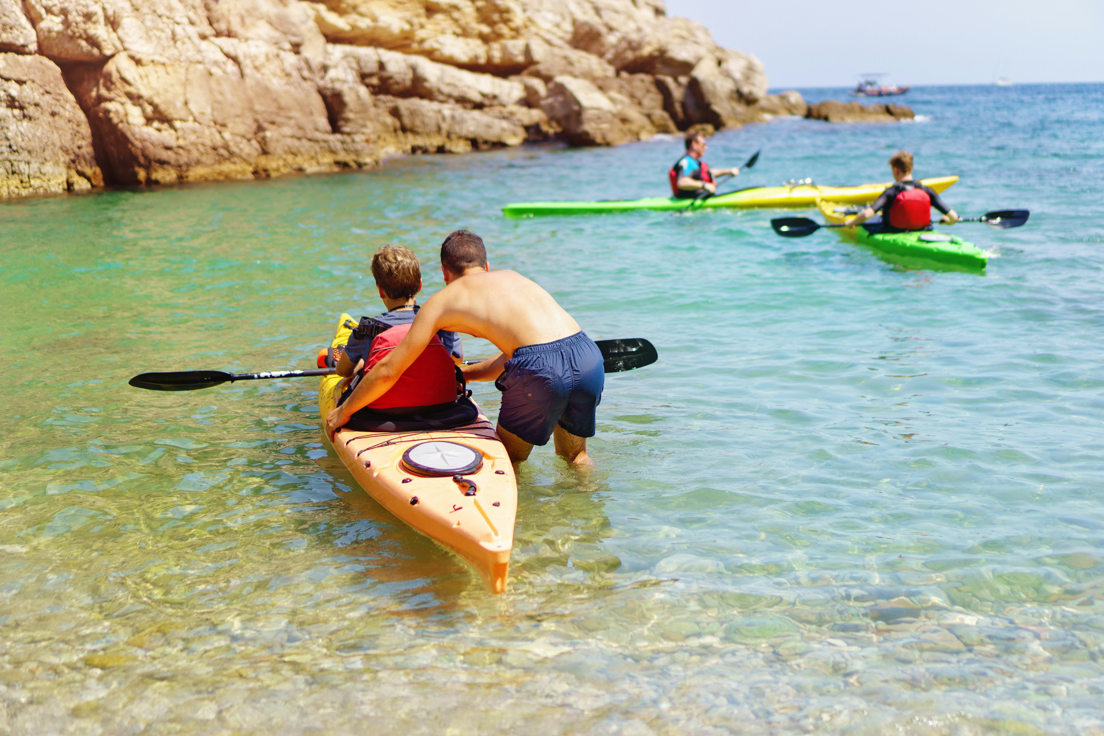 Young people setting out in kayaks from a beach, Sorrento, Amalfi Coast, Campania, Italy