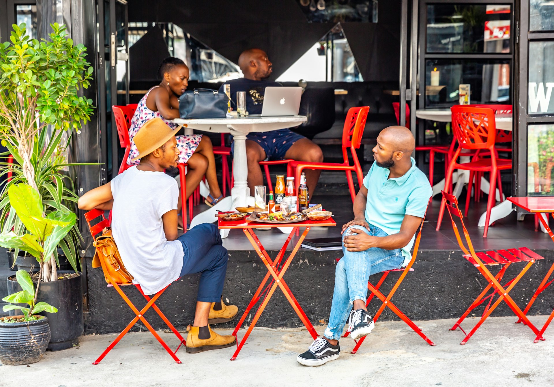 People at an outdoor cafe in Maboneng Precinct, Johannesburg, South Africa