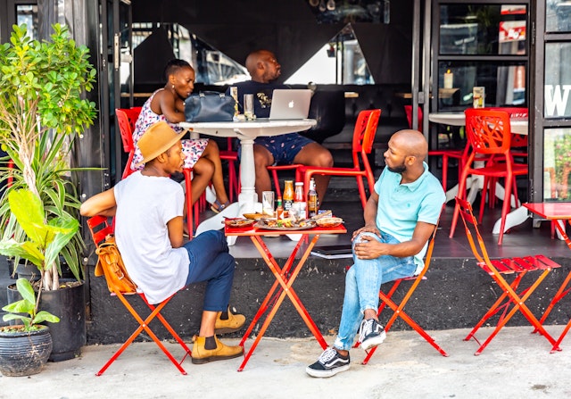 People at an outdoor cafe in Maboneng Precinct, Johannesburg, South Africa