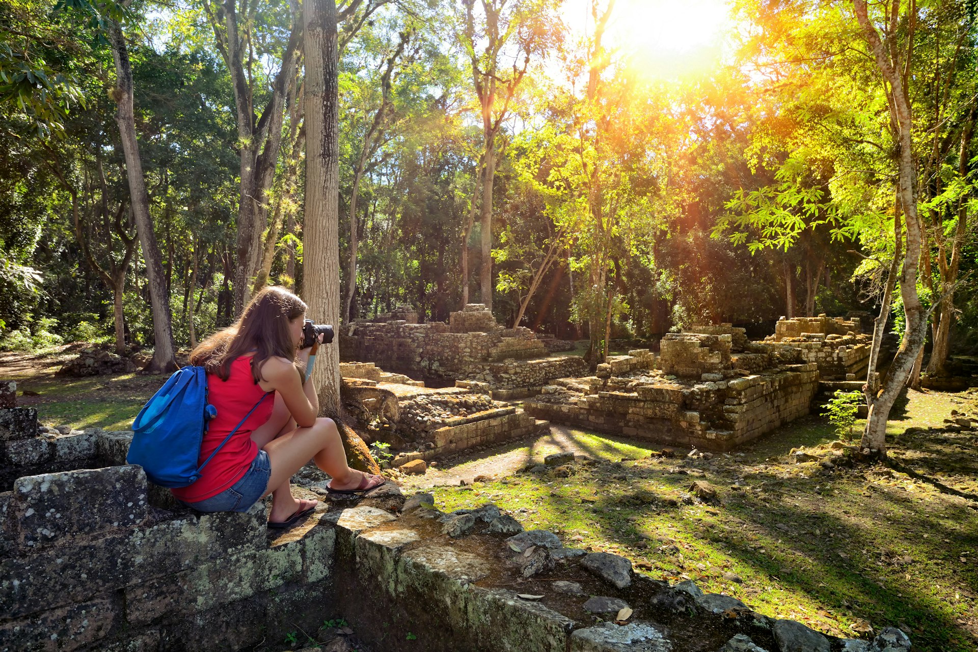 Woman photographing ancient Mayan ruins in Copan