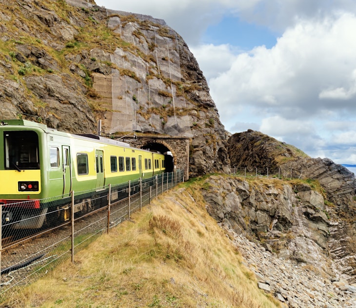 Closeup of train exiting a tunnel. View from Cliff Walk Bray to Greystones with beautiful coastline, cliffs and sea, Ireland; Shutterstock ID 1617672064; GL: 65050; netsuite: Lonely Planet Online Editorial; full: Getting around Ireland; name: Brian Healy
1617672064
beach, beautiful, bray, cliff, cliff walk, cliffs, cloudy, coast, coastal, coastline, countryside, dart, europe, exiting, exploring, green, greystones, hike, hiking, ireland, irish, landscape, motion, mountain, nature, no people, ocean, outdoor, path, railway, rocks, scenery, scenic, sea, seascape, stunning, summer, tourism, tracks, trail, train, travel, tunnel, vacation, view, walk, walkway, water, weather, wicklow