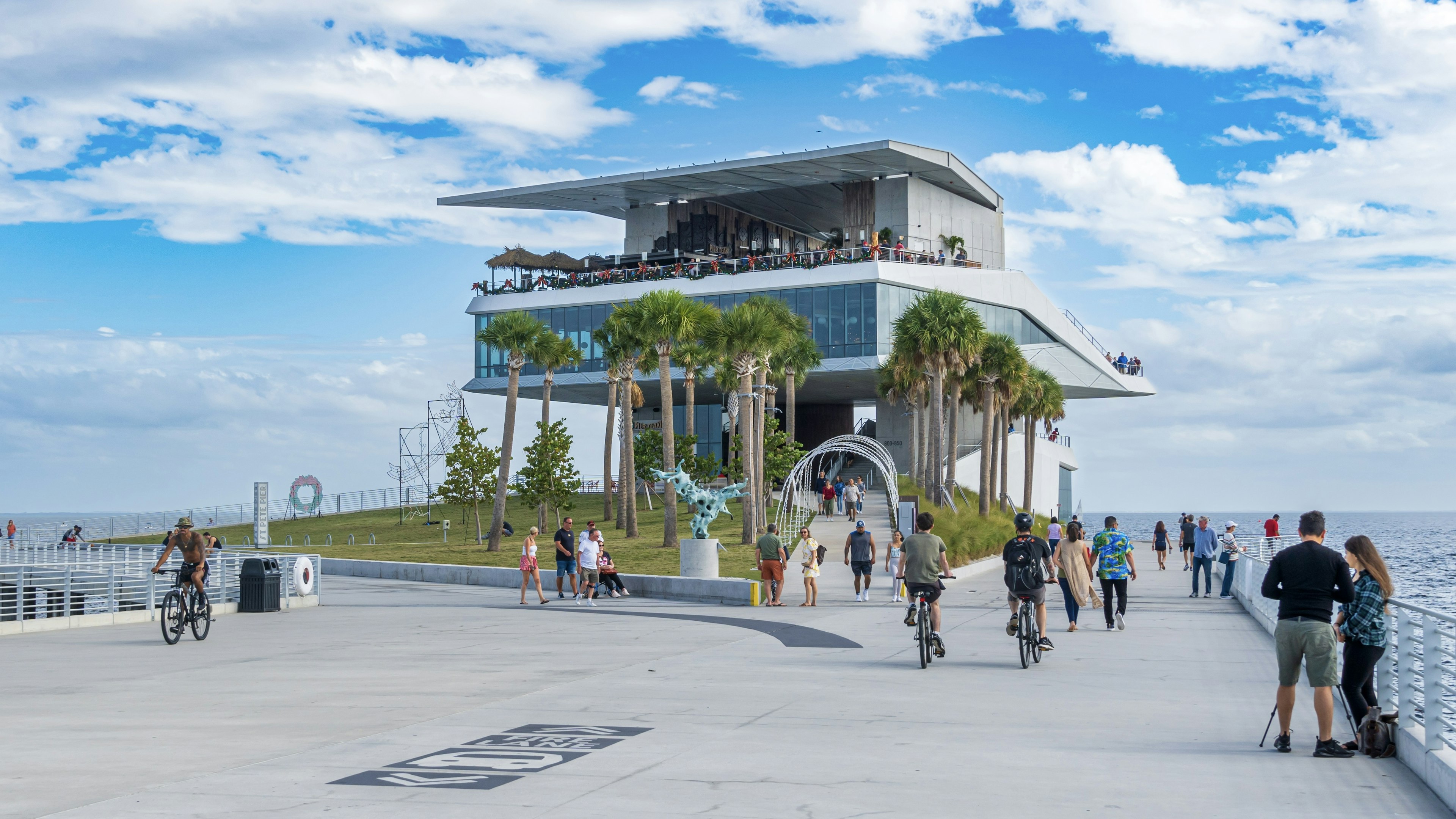 People walk and bicycle on the St Pete Pier, St Petersburg, Florida, USA