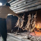 Argentina, Patagonia traditional lamb cooking on an open fireplace.; Shutterstock ID 2125211729; GL: 65050; netsuite: Lonely Planet Online Editorial; full: Where to eat and drink in Argentina; name: 65050
2125211729
america, argentina, argentinian, asada, asado, asador, barbecue, beef, cook, cooked, cooking, cordero, cuisine, culture, delicious, dish, estancia, fire, fire gastronomy, fireplace, firewood kitchen, flame, food, gastronomy, gaucho, grill, grilled, hot, lamb, lamb ribs, meat, pampas, patagonia, patagonia argentina, raw, roast, roasted, roasting, rotisserie, rustic, sheep, smoke, south, tradition, traditional, traditional kitchen, travel, travel destination, typical, vertical