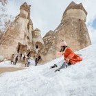 happy little girl in red sliding on a pile of snow in pasabag valley cappadocia; Shutterstock ID 2188765535; GL: 65050 ; netsuite: Online Editorial; full: Cappadocia articles; name: Tasmin Waby
2188765535