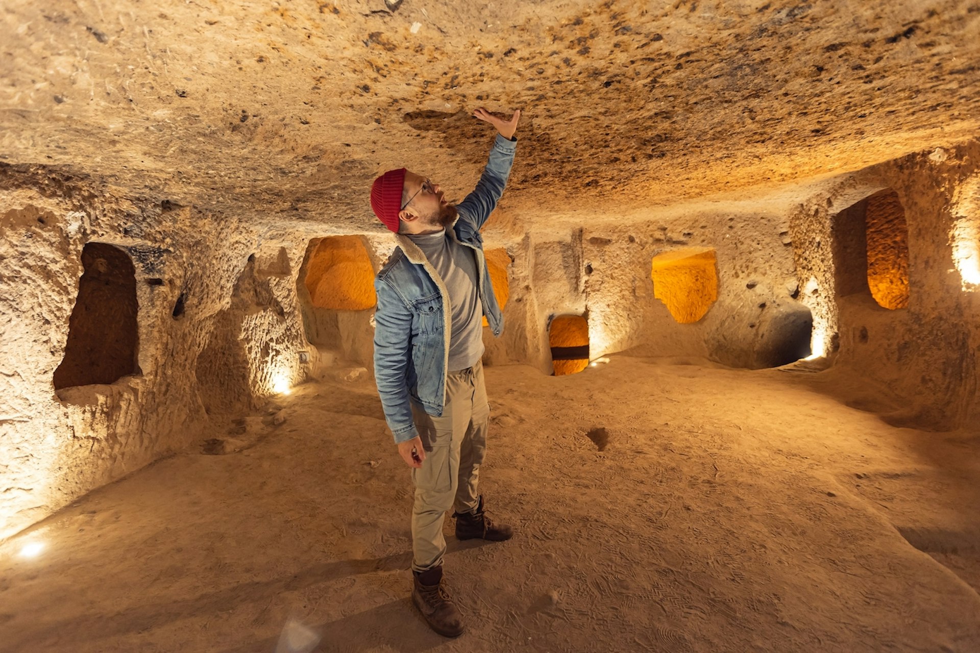 Tourist man in Kaymakli underground city ancient cave in Cappadocia, Turkey