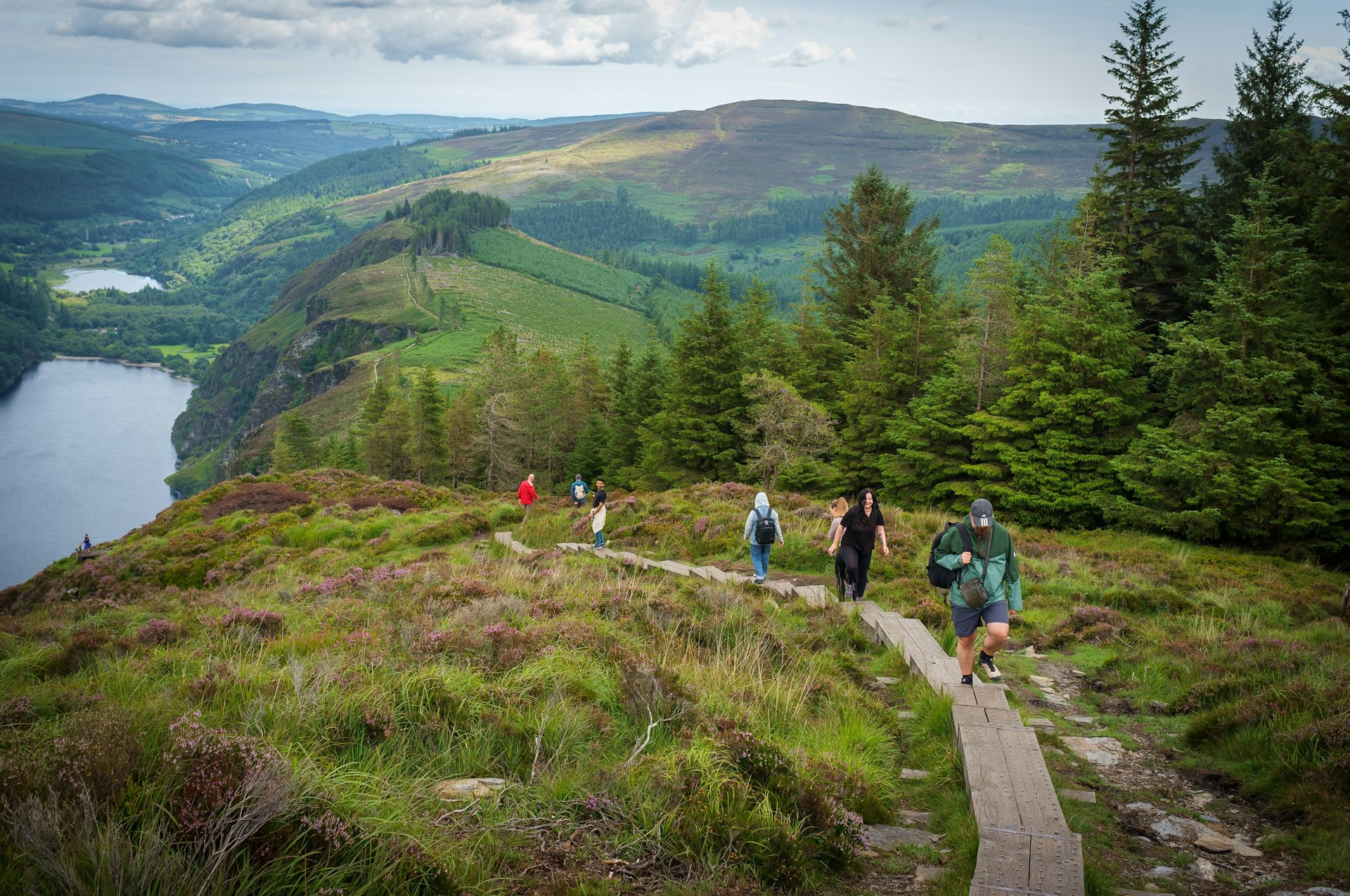 Hikers along a trail in Glendalough, Wicklow Mountains, Ireland