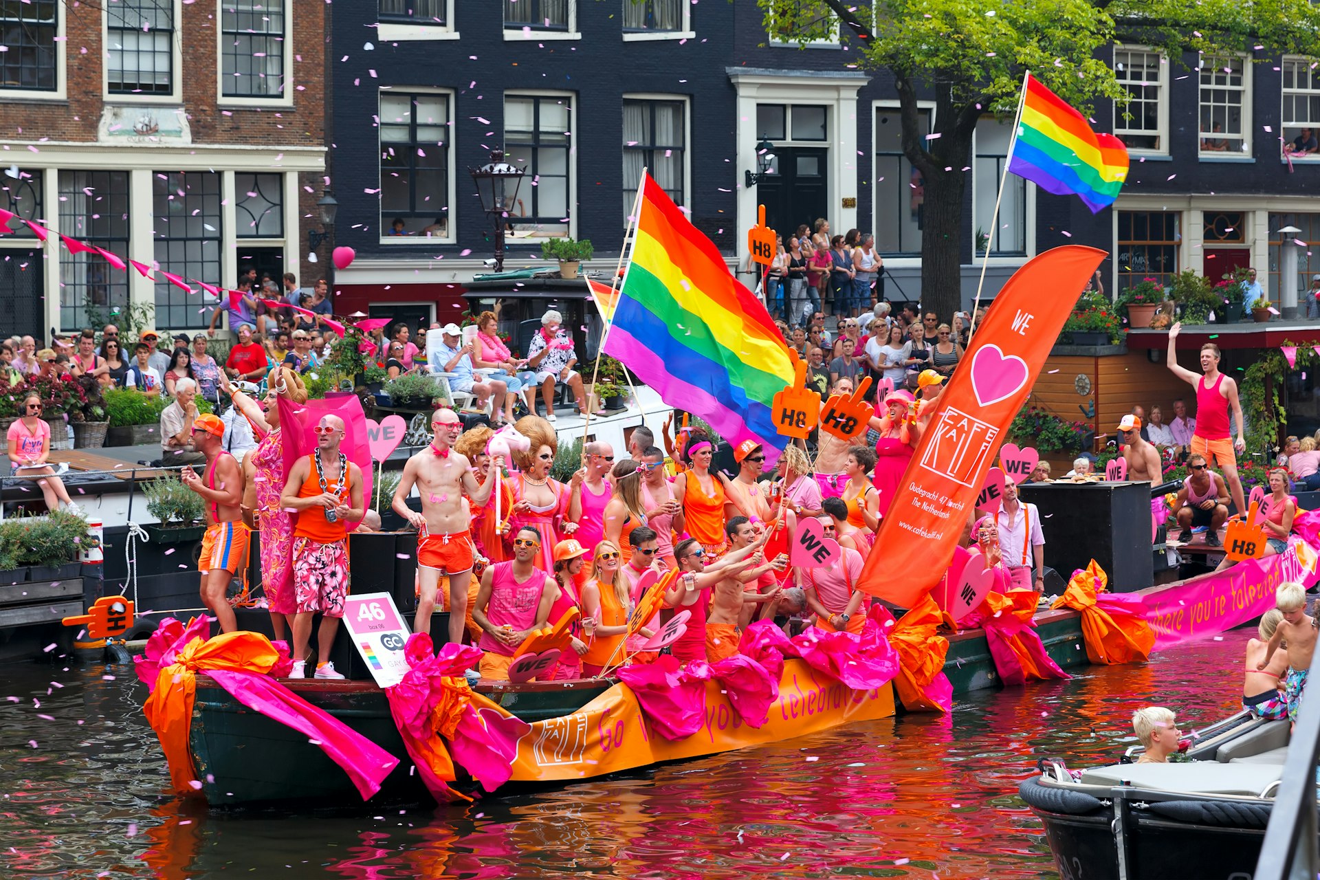 People celebrate on a float boat at the Amsterdam Pride Parade, Amsterdam, the Netherlands