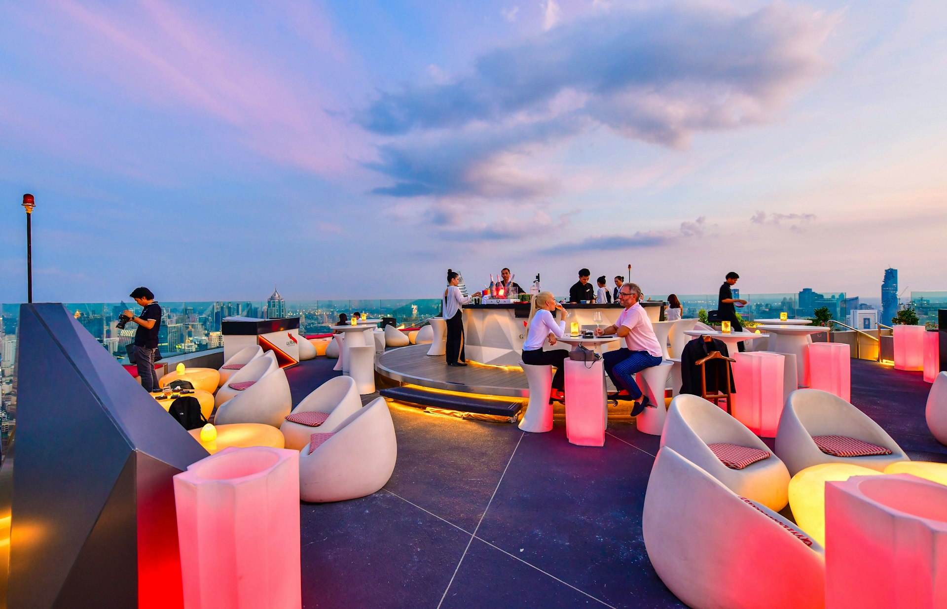 : Twilight view from CRU Champagne Bar at Centara Grand at Central World, overlooking a magnificent cityscape of Bangkok.