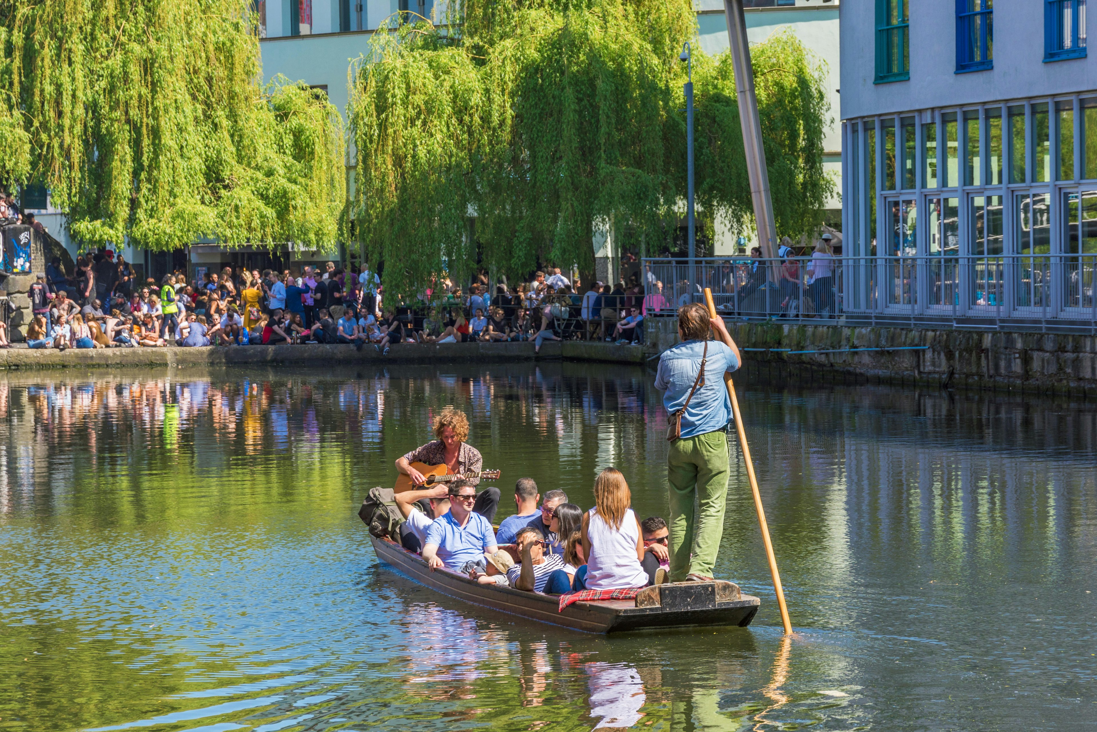 : Passengers on a punt on the Regent's Canal in Camden lock.