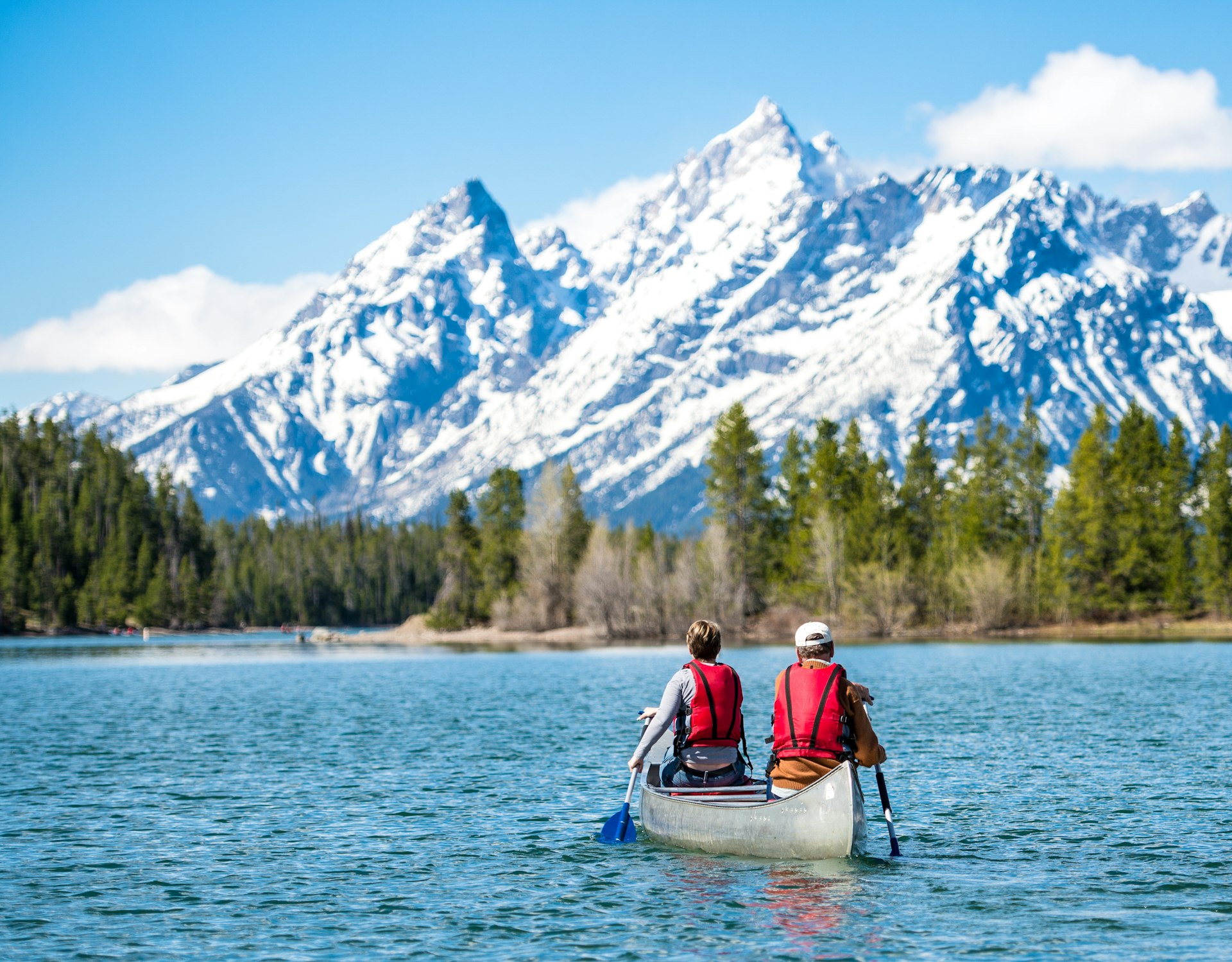 Father and daughter canoeing on Jackson Lake, Grand Teton National Park, Wyoming, USA