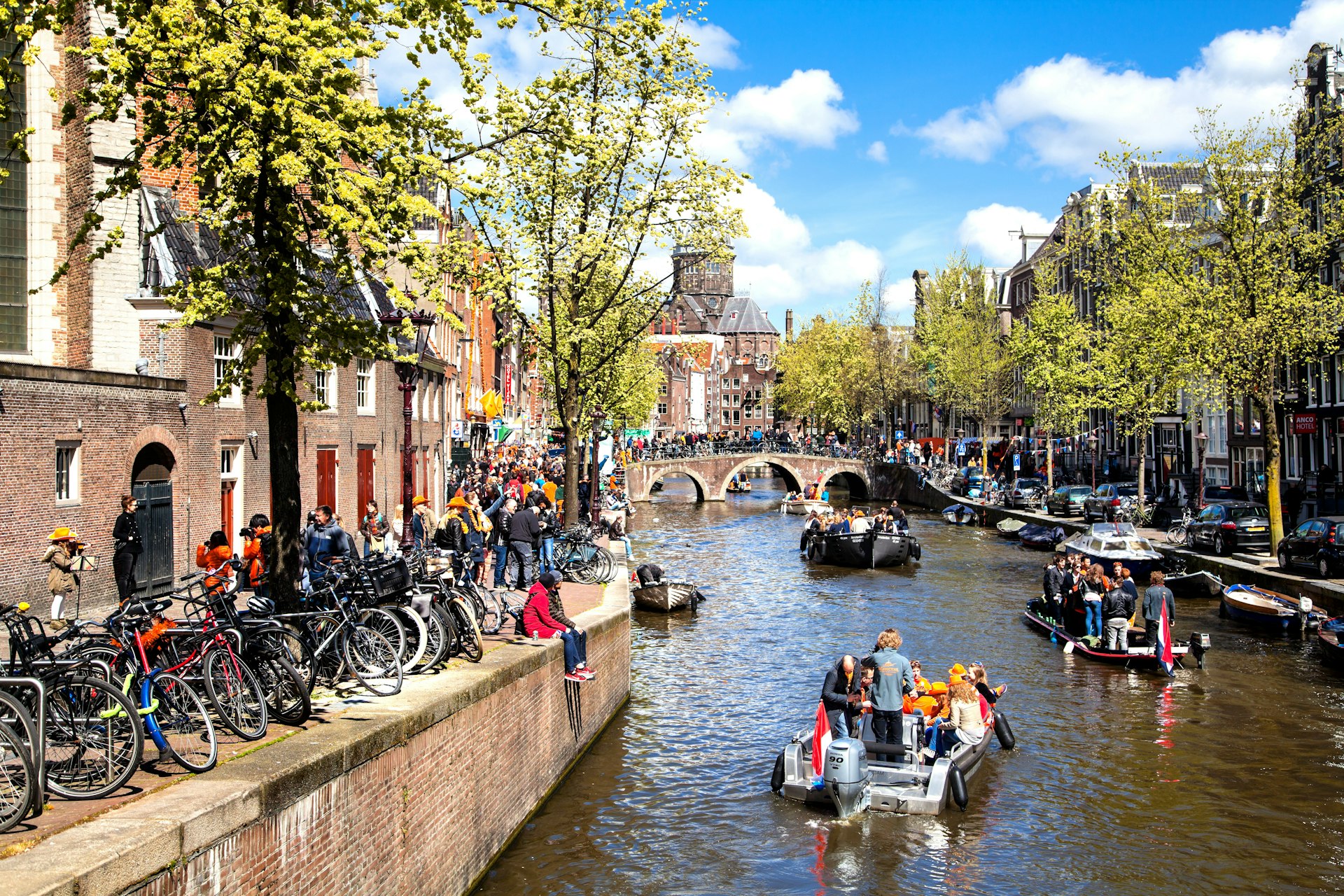 Streets and Canals of Amsterdam full of people dressed in orange celebrating King's day on April 27, 2015 in Amsterdam, 