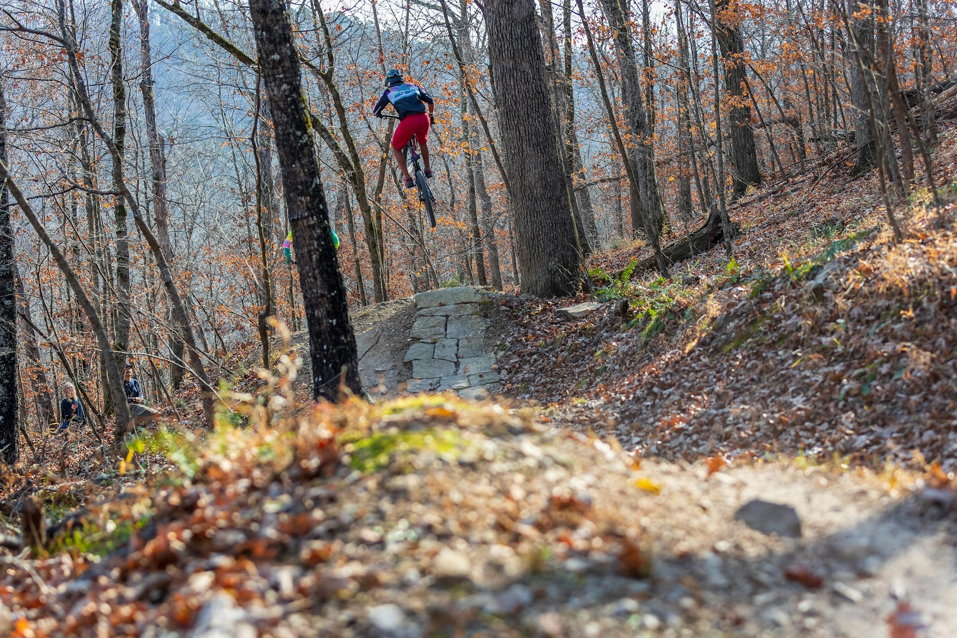 A mountain biker gets some air on a trail in the Ozarks