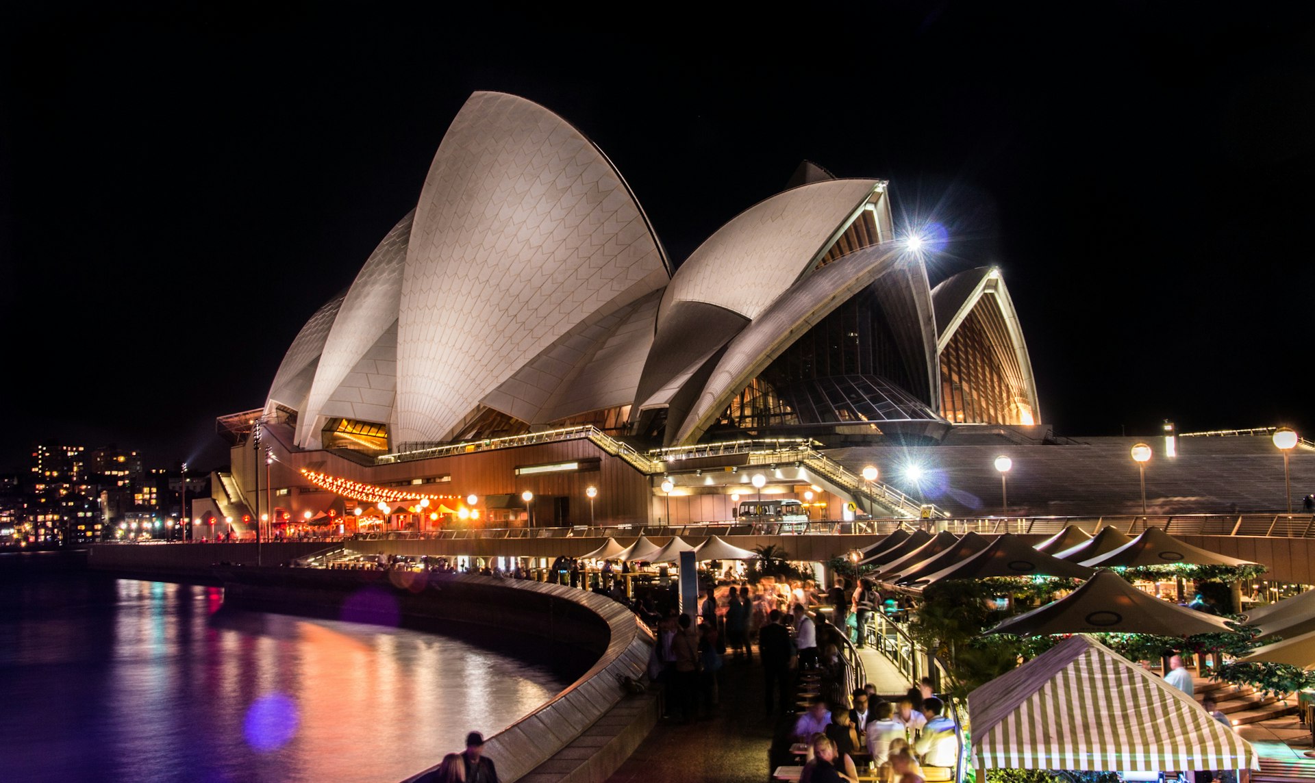 Crowds outside the illuminated Sydney Opera House at night, Sydney, New South Wales, Australia