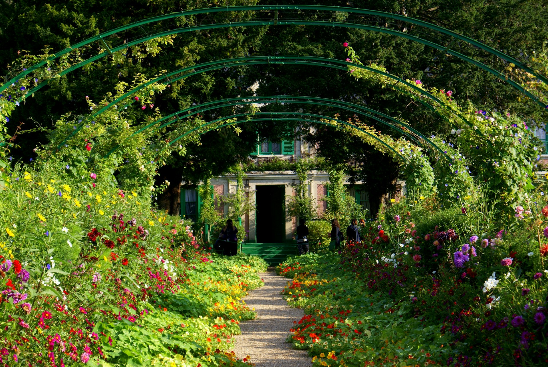 A green archway with flowers at Claude Monet’s garden at Giverny, Normandy, France