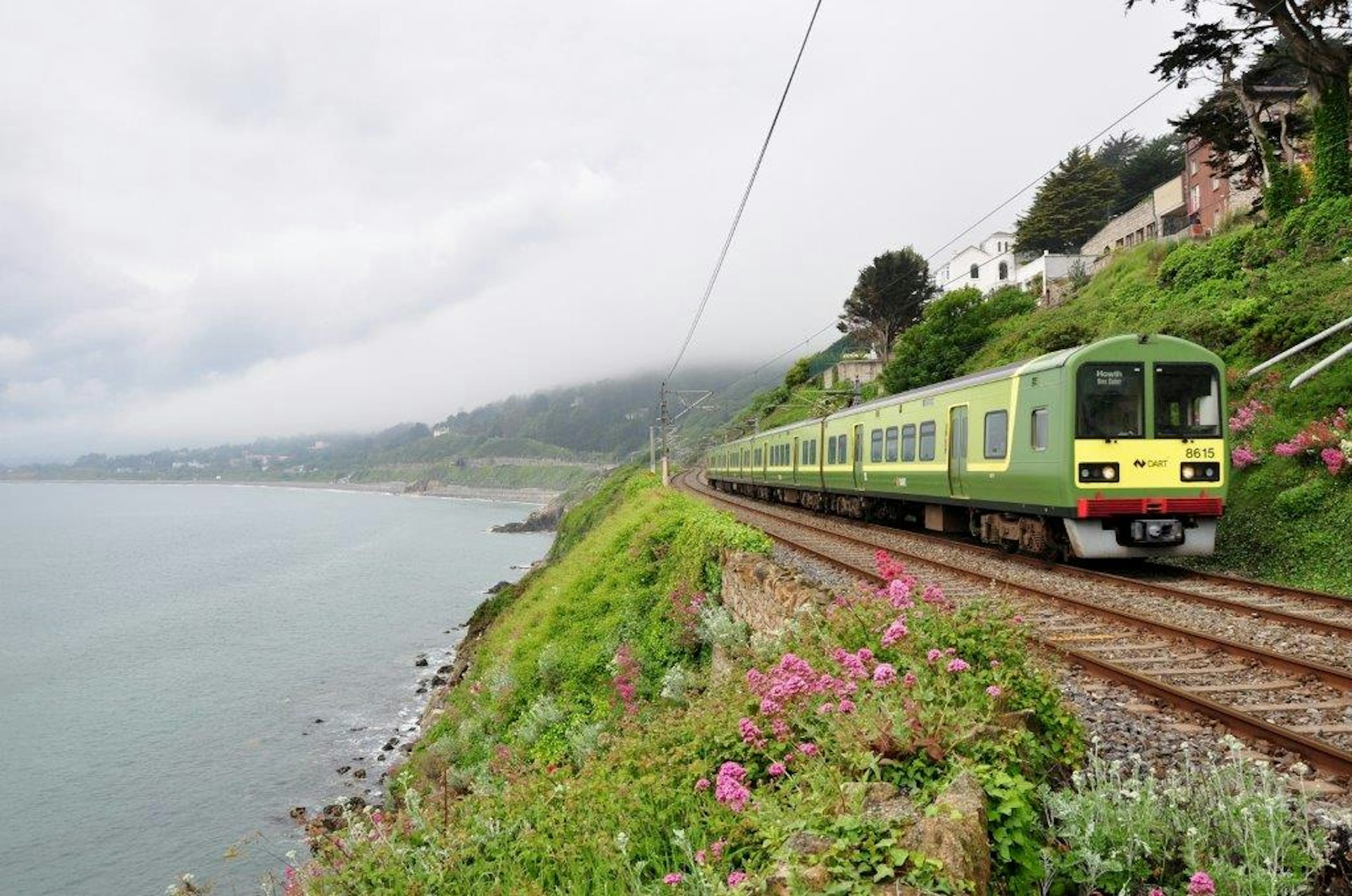 A train follows a scenic route by the sea
