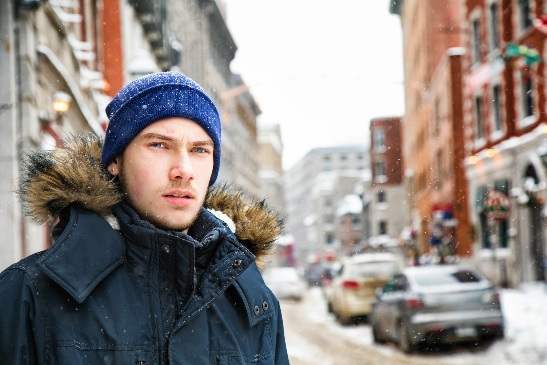 A young man in a snowy street in Vieux Montréal, Québec, Canada