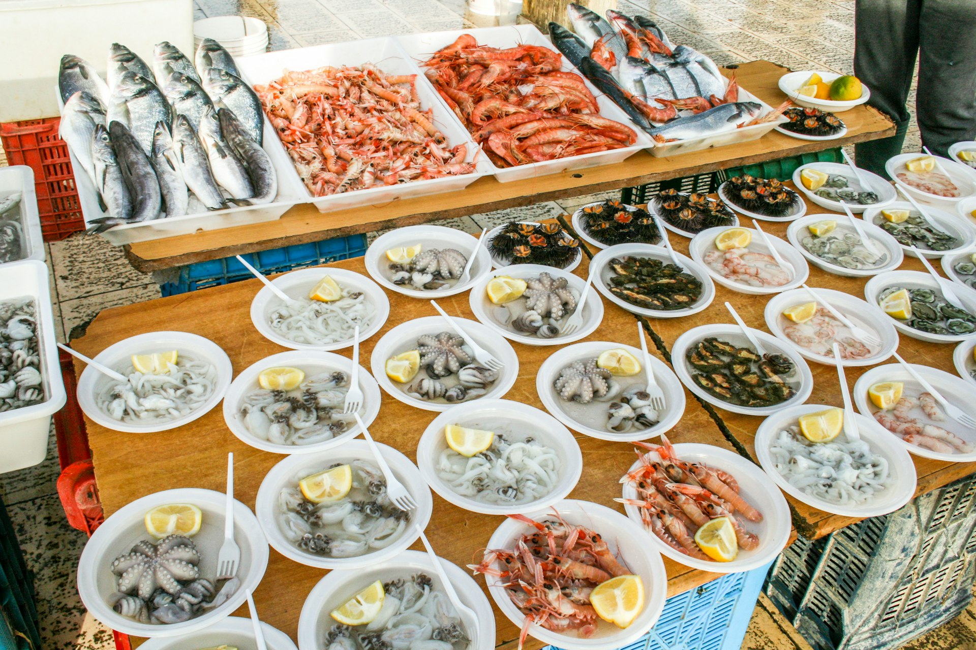 Open air street food fish market on Bari promenade with raw fresh fish ready to eat