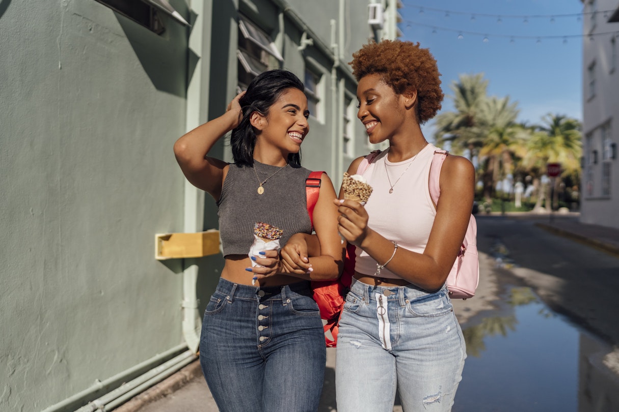 Two women smiling and eating ice cream cones in Miami Beach, Florida