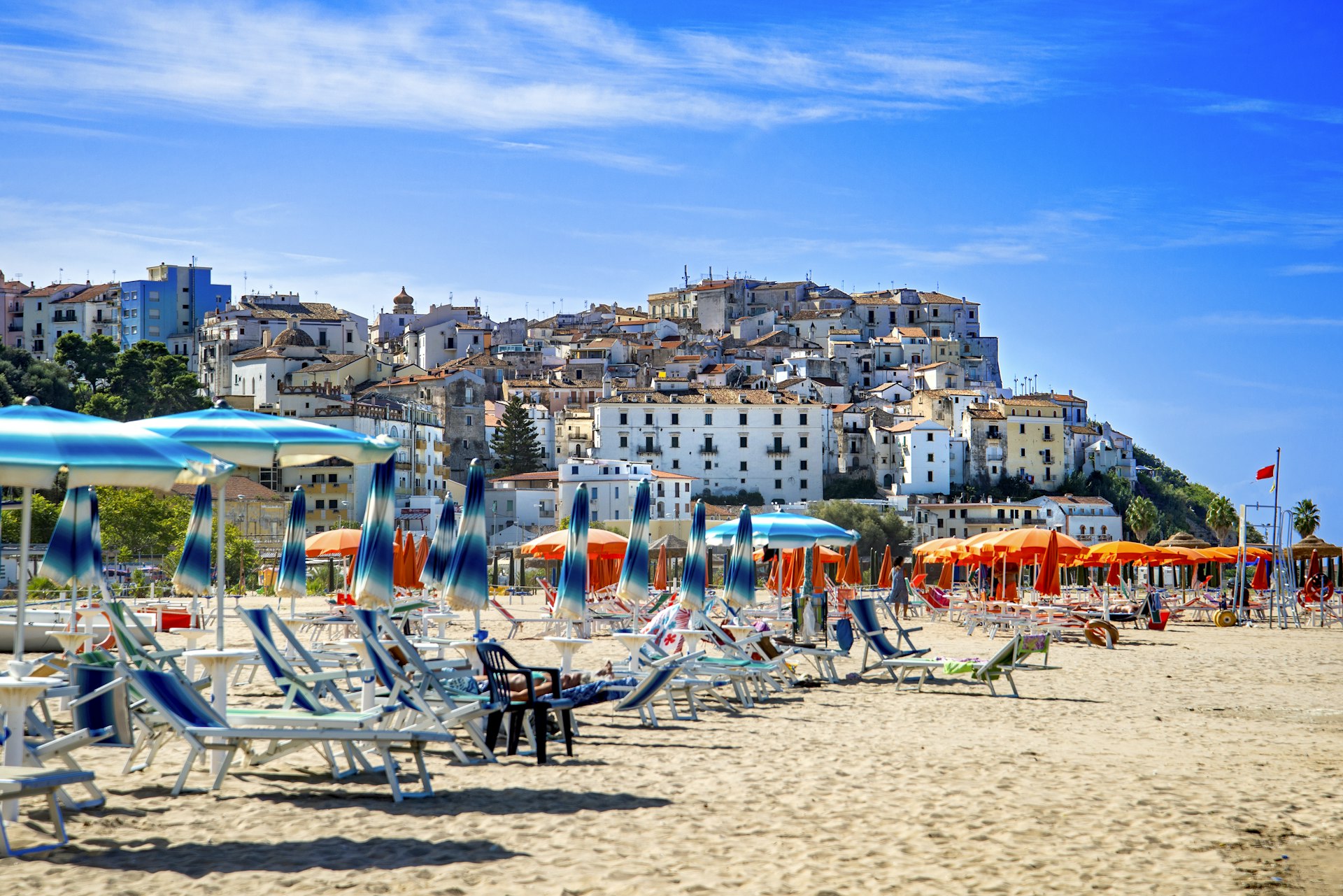 Umbrellas and lounge chairs on the beach of Rodi Garganico in summer