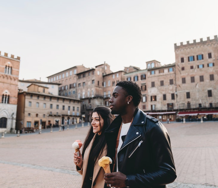 Young adult couple walking in Siena with an ice-cream. They are in Piazza del Campo, Siena, Italy.
1389927604
