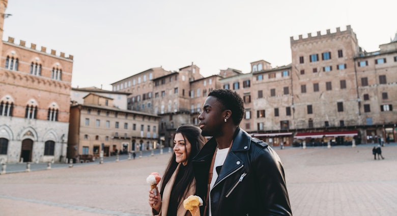 Young adult couple walking in Siena with an ice-cream. They are in Piazza del Campo, Siena, Italy.
1389927604