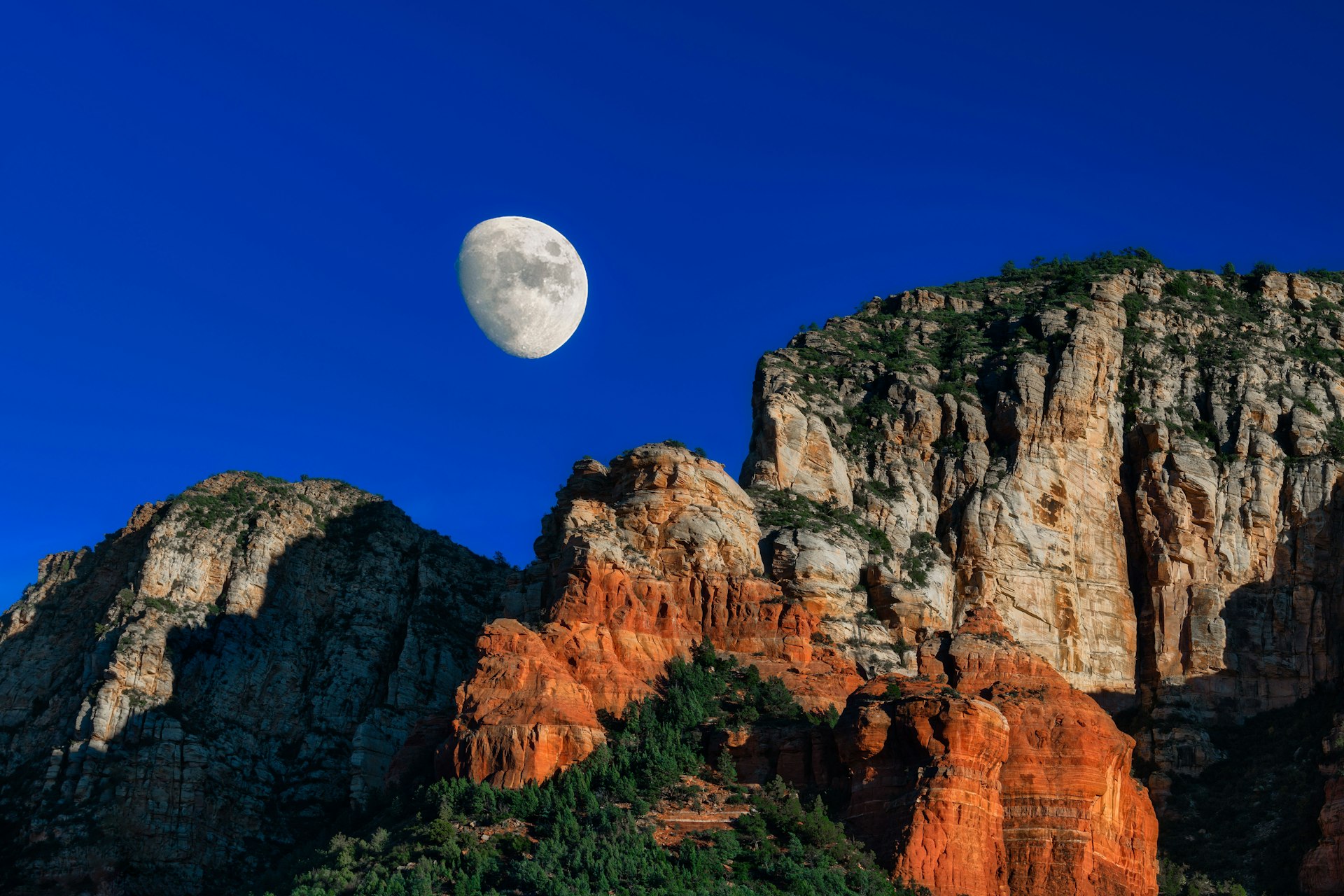 A full moon over rock formations at night, Sedona, Arizona, USA