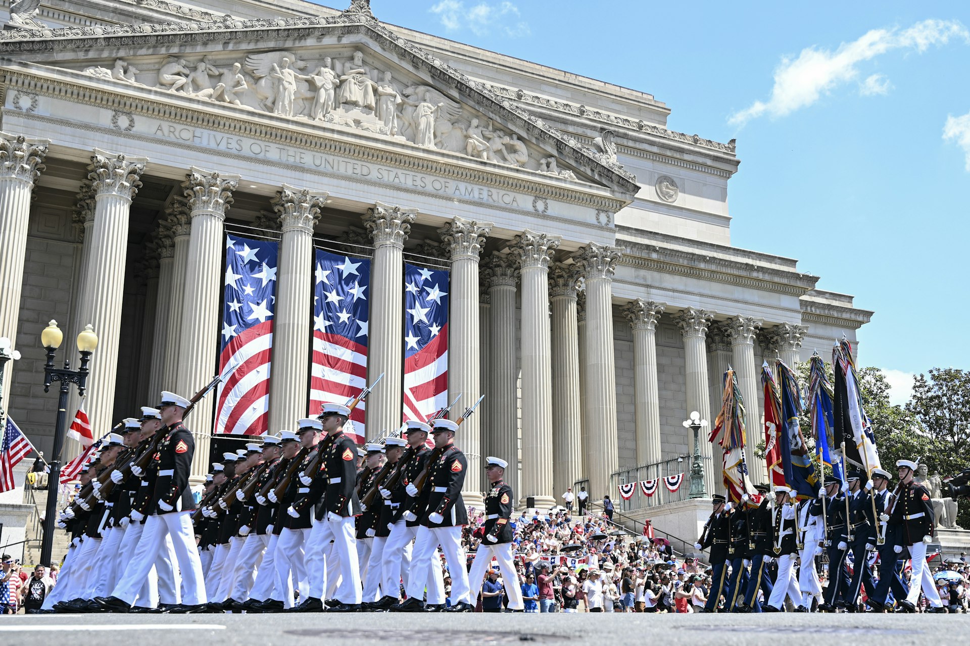 A military parade passes in front of the National Archives during Fourth of July celebrations in Washington, DC