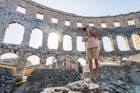A woman takes photos of the Coliseum in Pula
1765514597