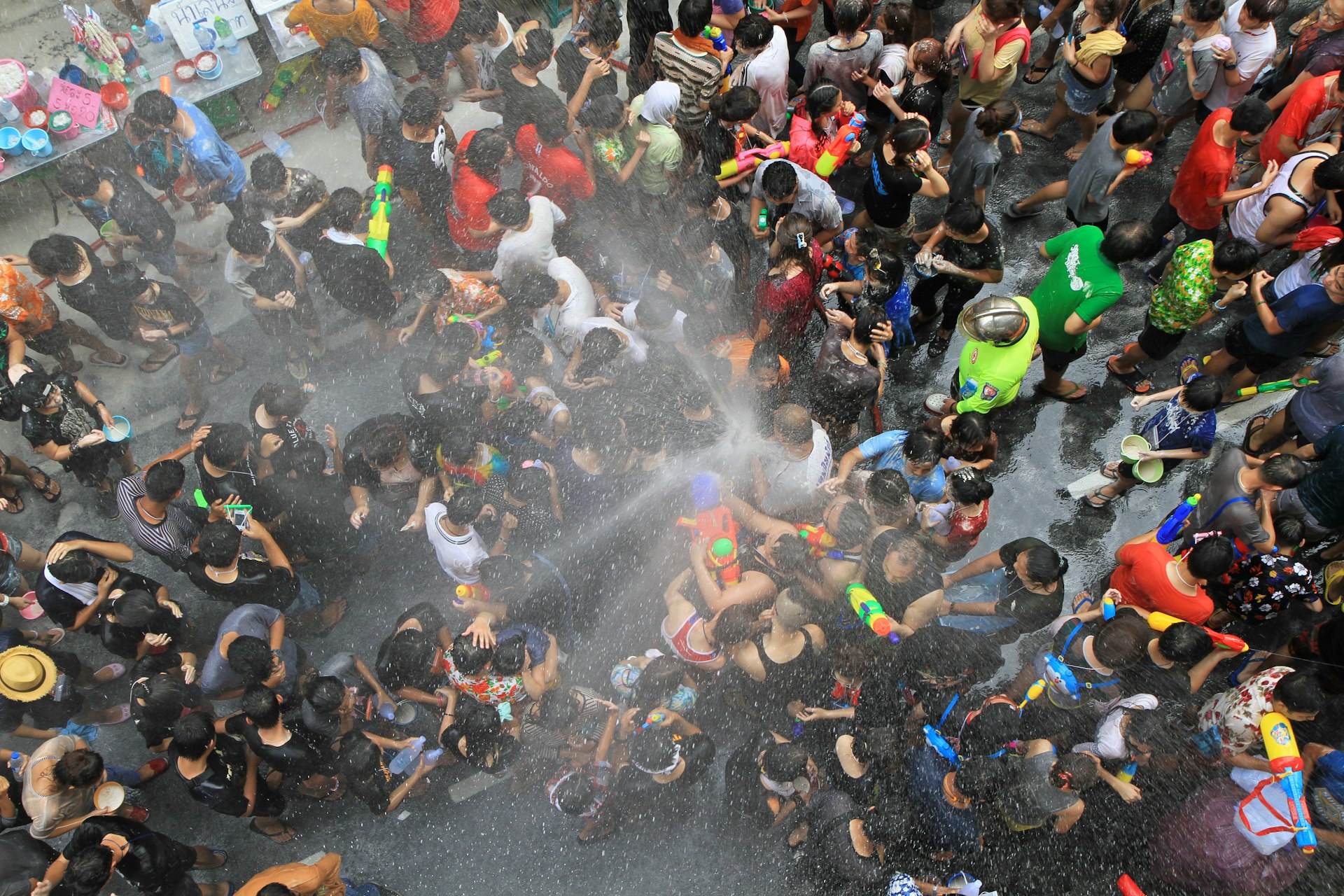 People at a Bangkok street party get sprayed with water