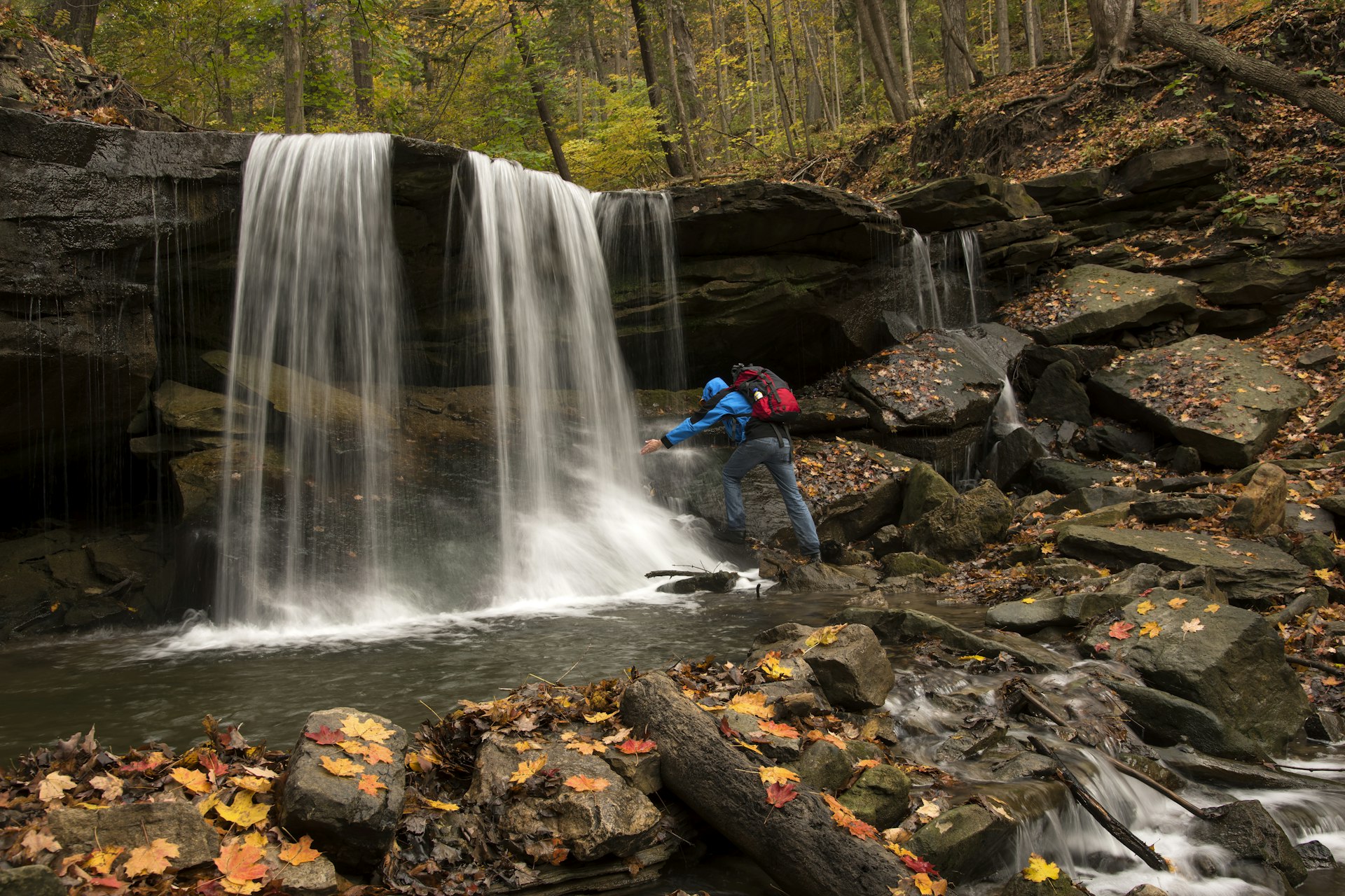 A male hiker by Lower Tews Falls, along Bruce Trail, Hamilton, Ontario, Canada
