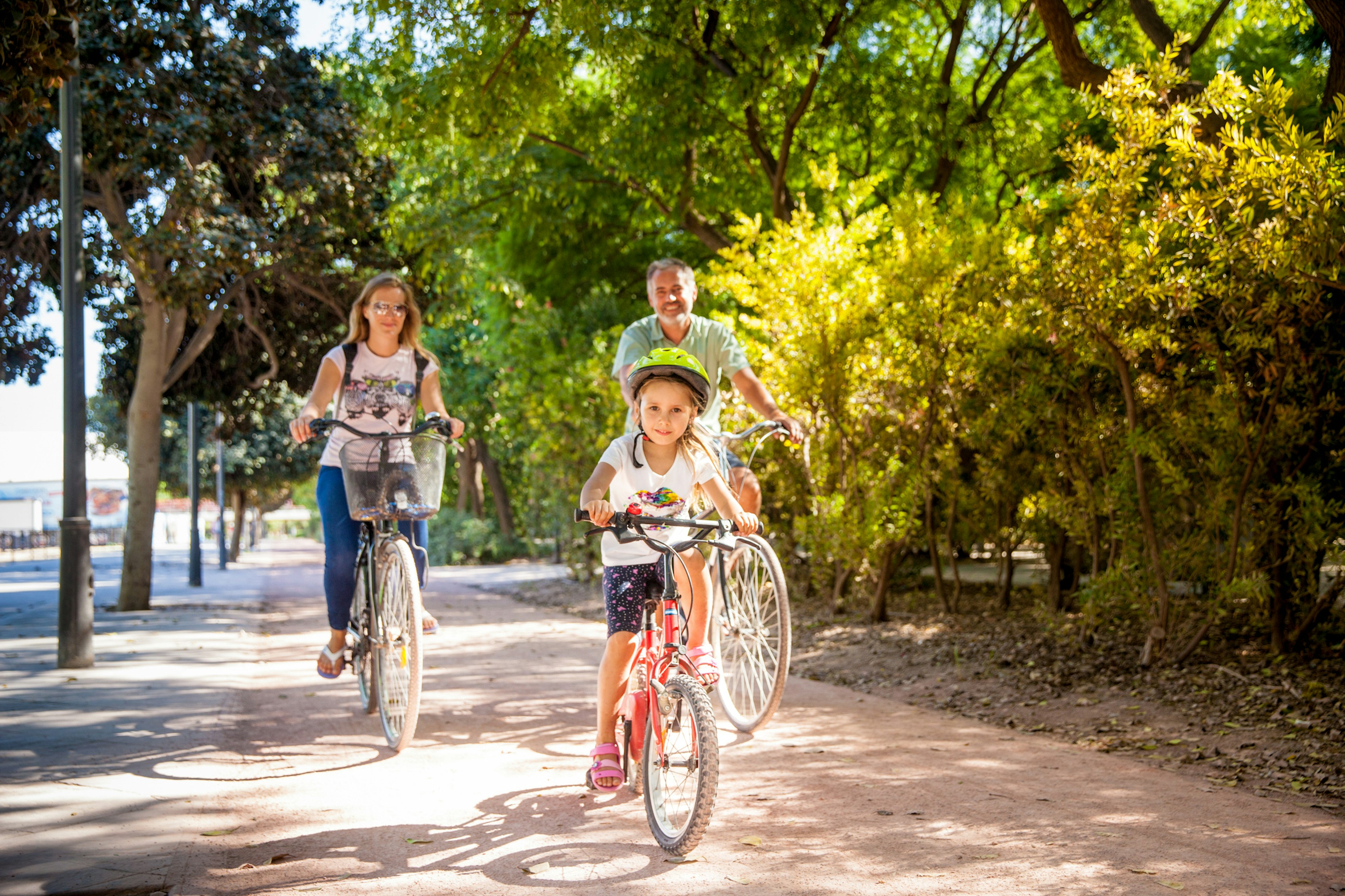 Father With Two Daughters Riding Bike In Valencia