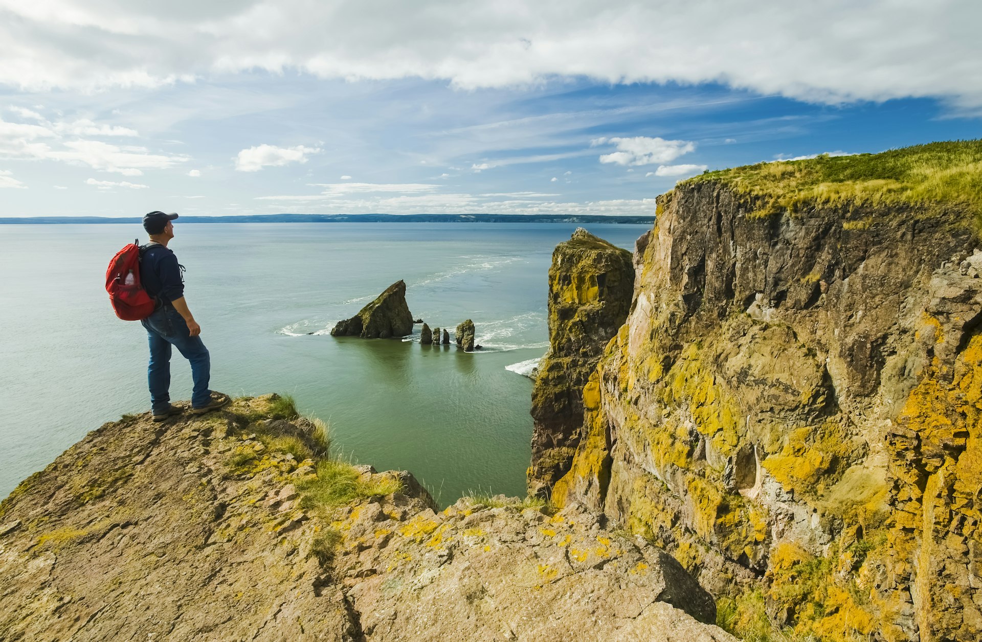 Um caminhante observa a Baía de Fundy de Cape Split, Nova Escócia, Canadá