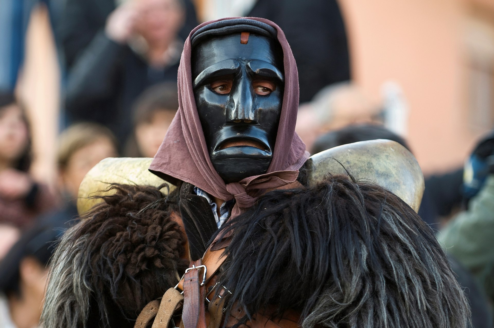 Costumed, masked ”mamuthones,” men clad in hand-carved black masks and shaggy sheepskins, Mamoiada, Sardinia, Italy