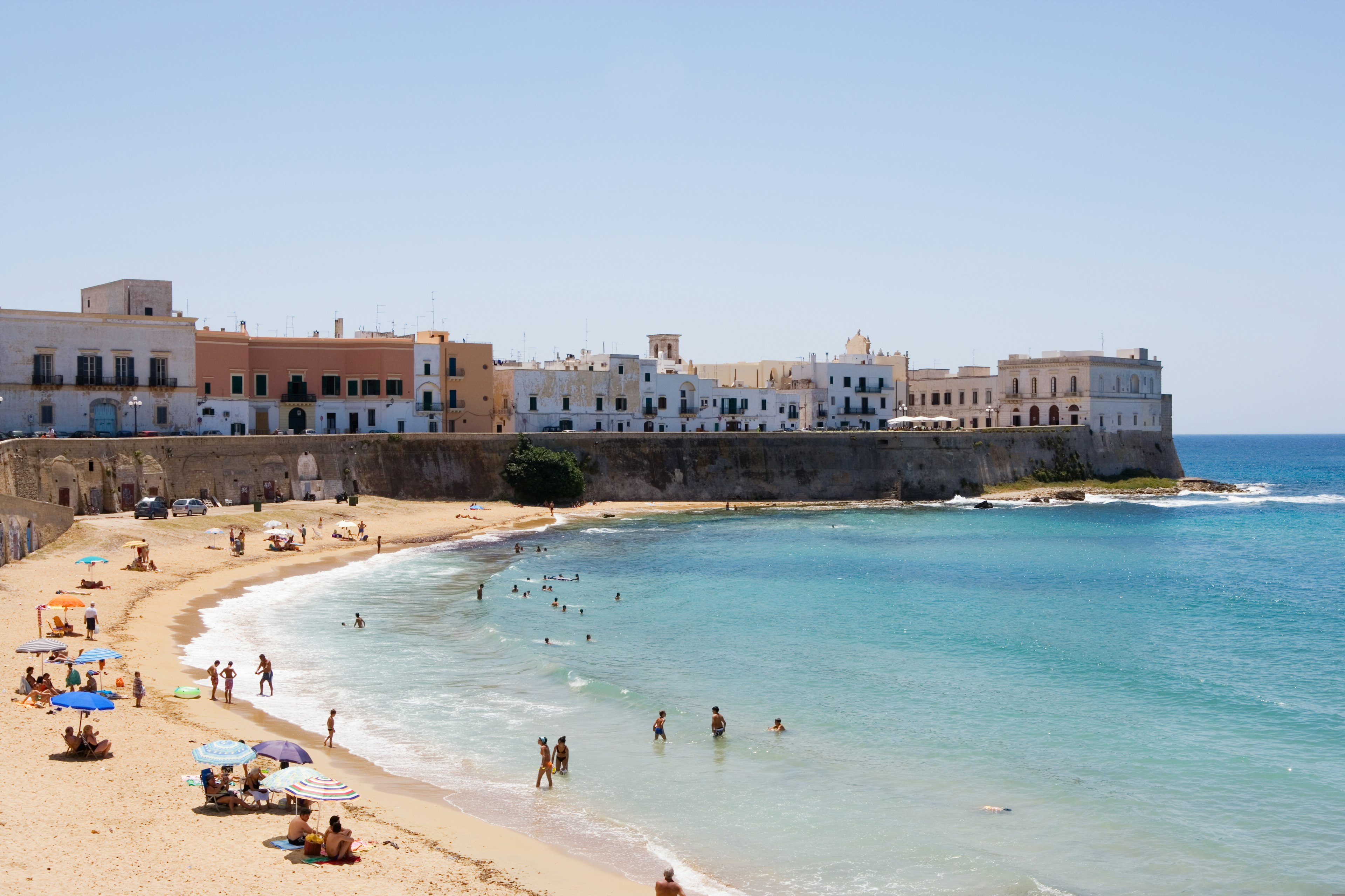 People relax on a beach in Puglia