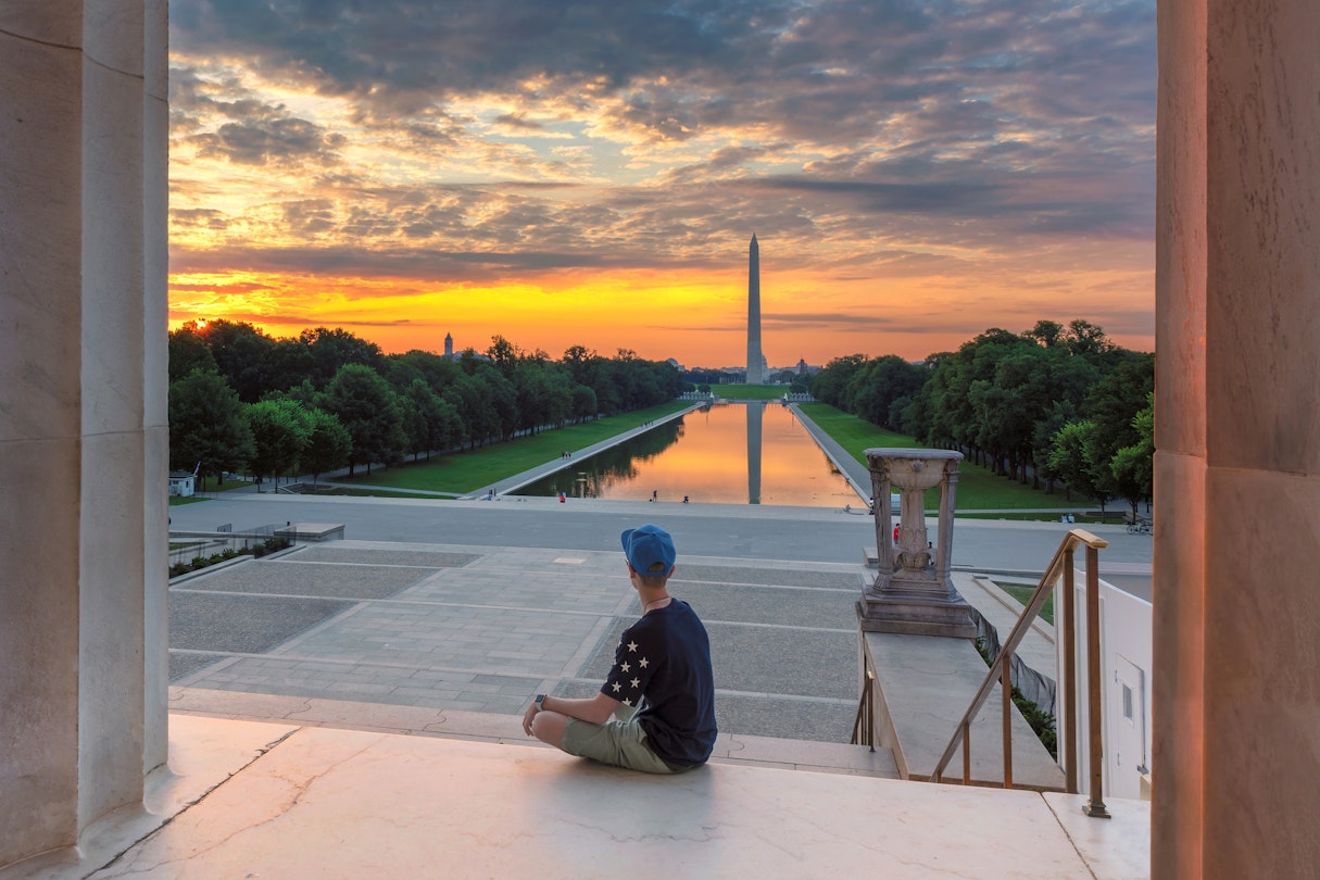 Teenager meets dawn at the Lincoln Memorial in morning summertime. Washington Monument Sunrise from Lincoln Memorial, Washington DC, USA.
998940796
