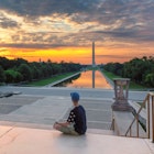 Teenager meets dawn at the Lincoln Memorial in morning summertime. Washington Monument Sunrise from Lincoln Memorial, Washington DC, USA.
998940796