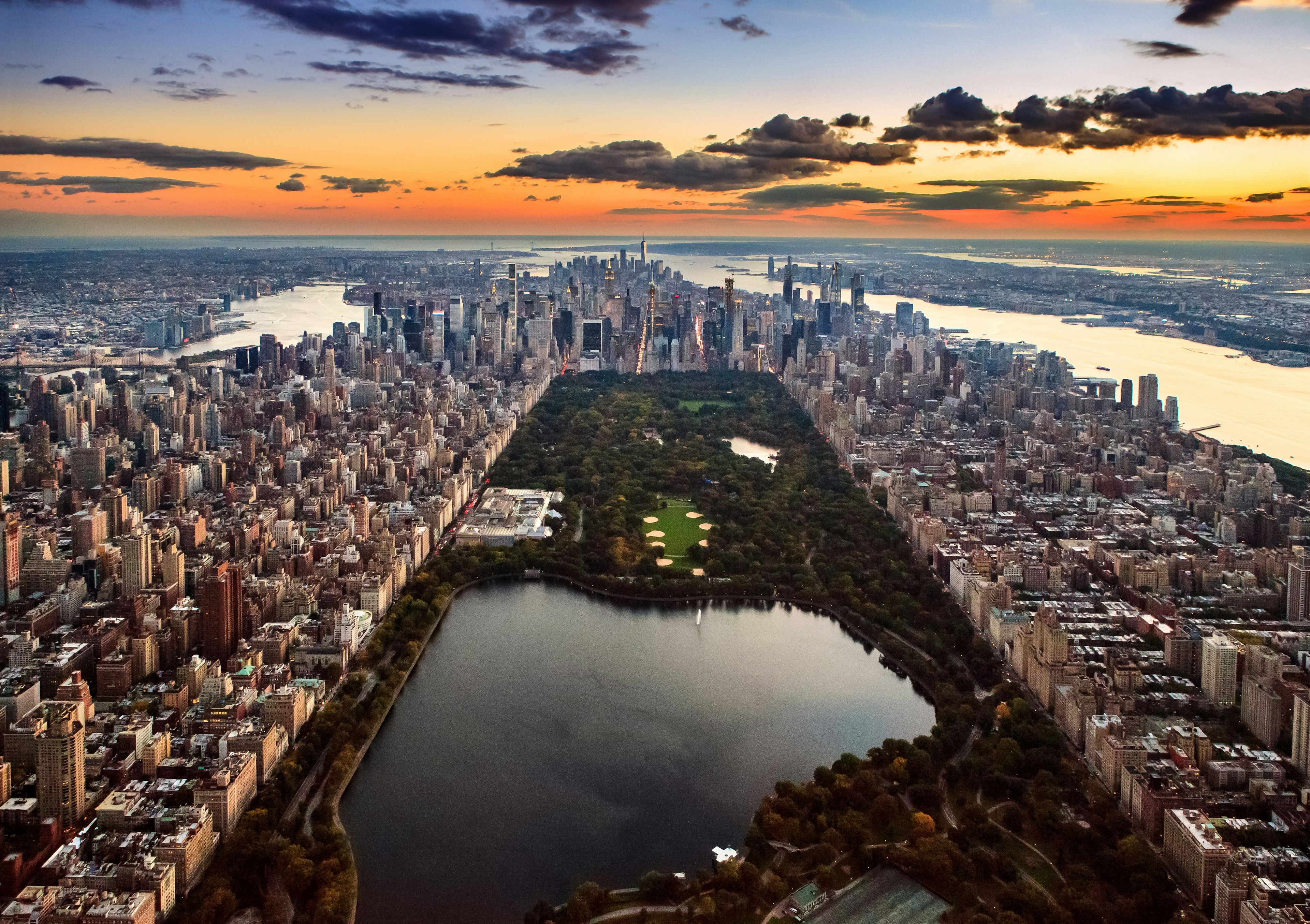 Aerial view of a huge expanse of parkland within a city full of high-rise building