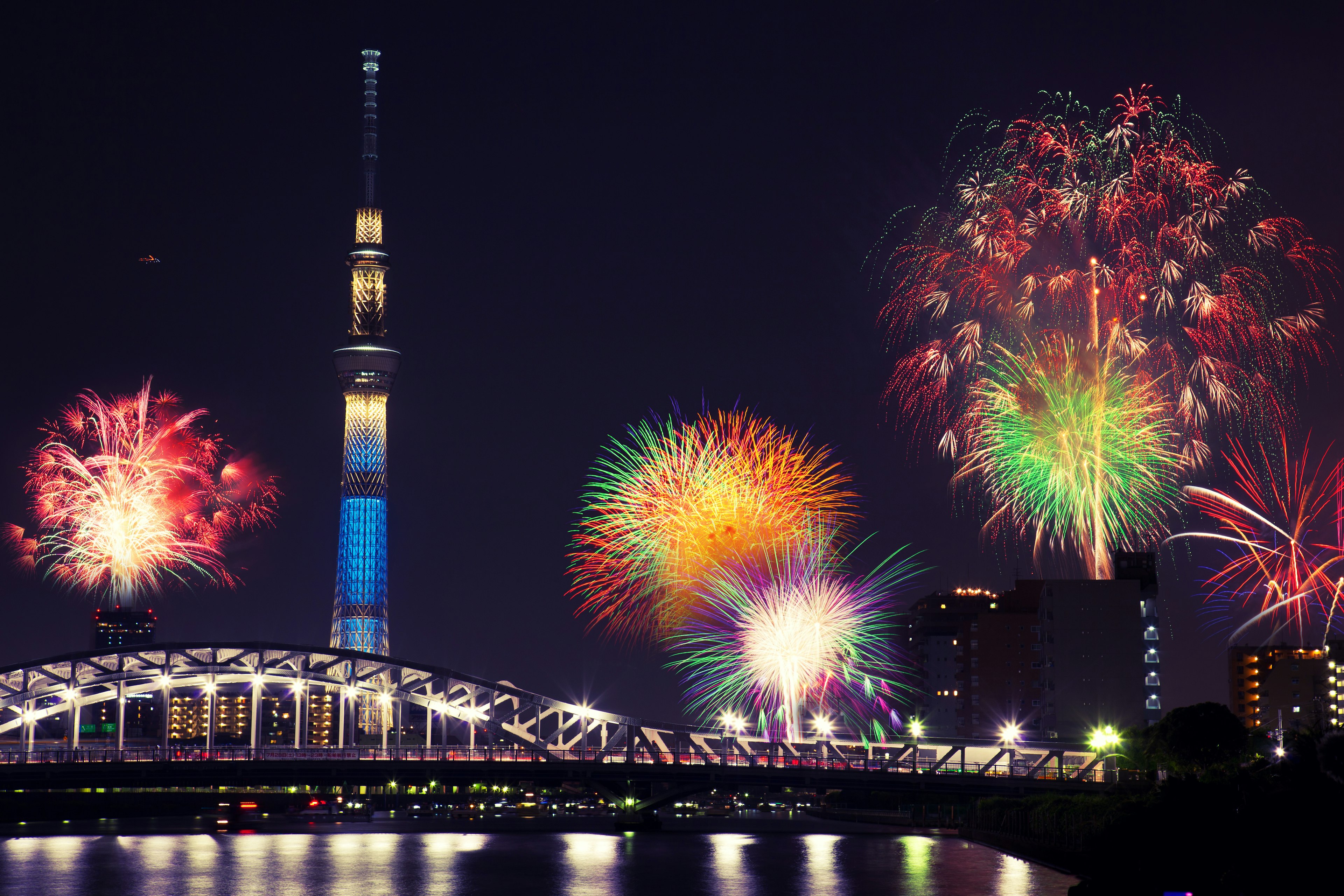 Summer fireworks over the Sumida river at night in Tokyo Japan