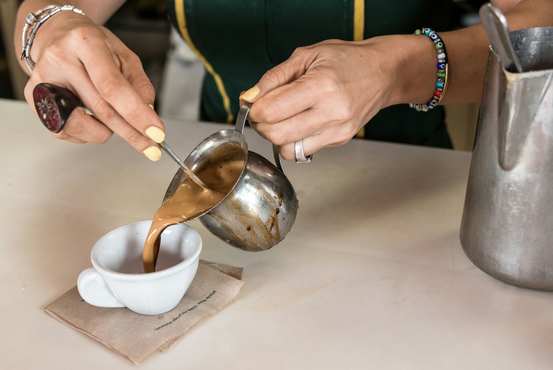 Woman serving a Cuban espresso coffee at a cafe in the Little Havana neighborhood, Miami, Florida, USA