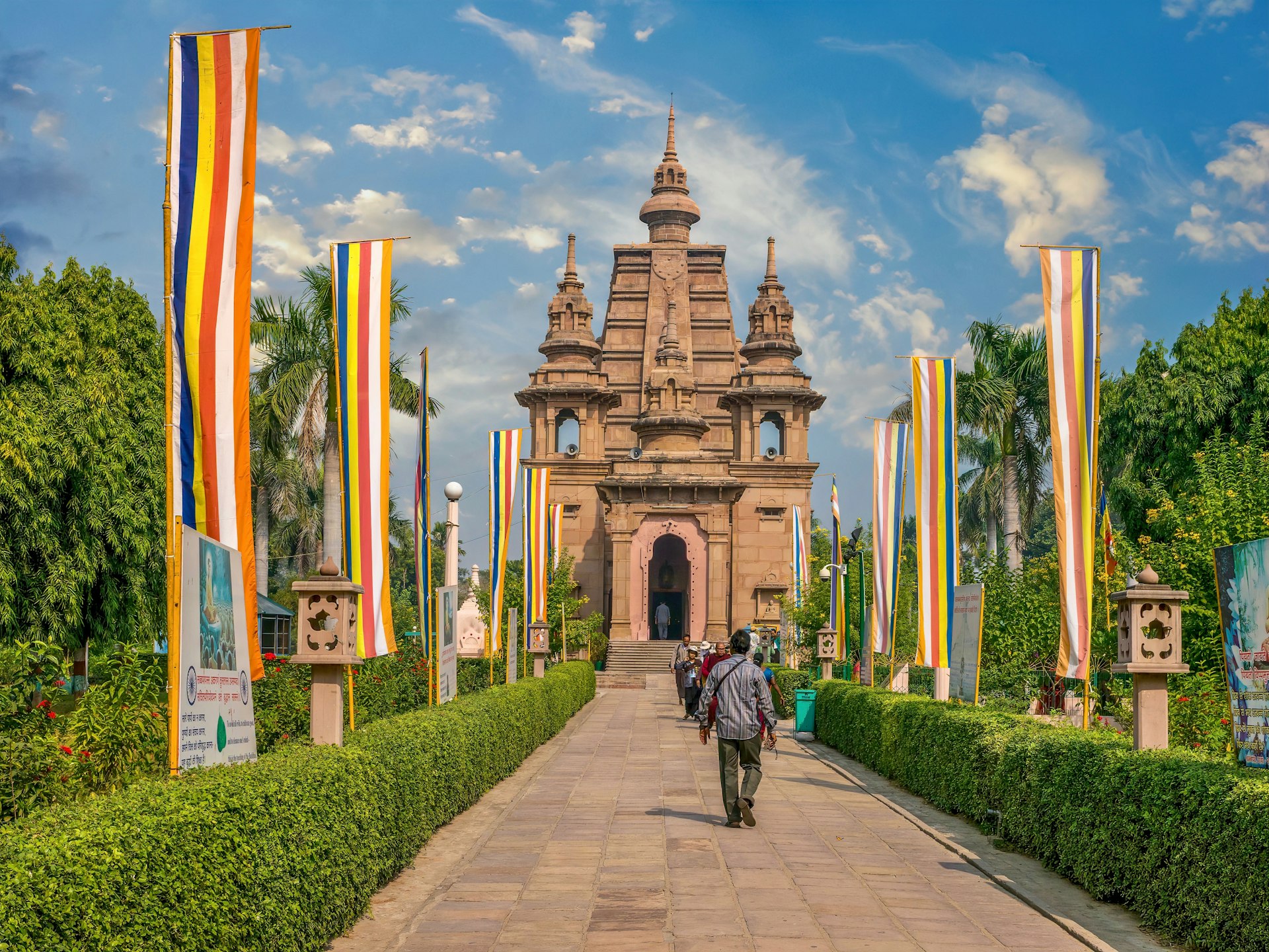 A person walks towards the entrance of a monastery and temple building